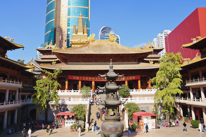 Traditional temple courtyard with modern skyscraper background