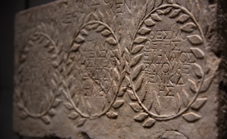 Ancient stone tablet with greek inscriptions and laurel wreaths