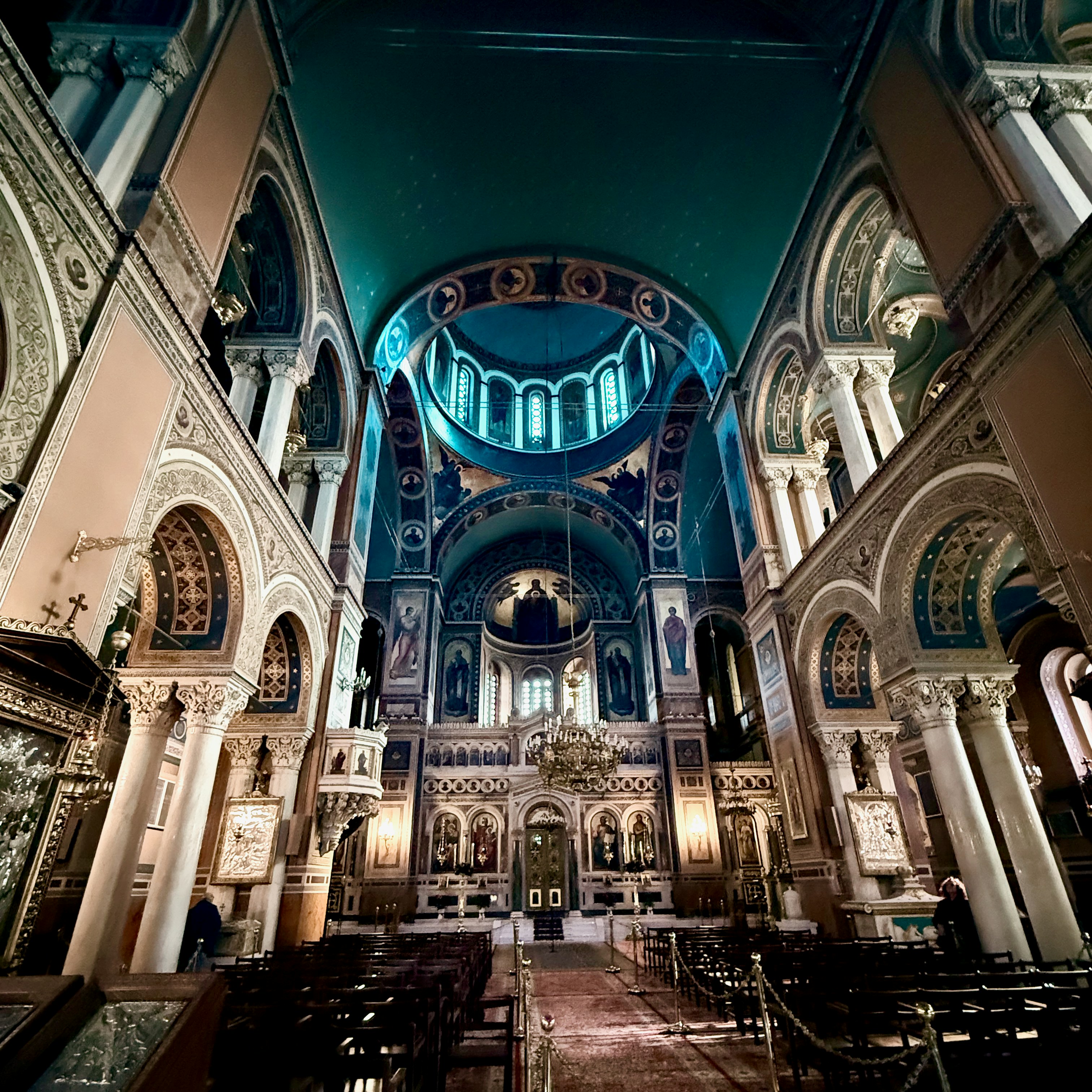 Interior of an ornate cathedral with blue domed ceiling