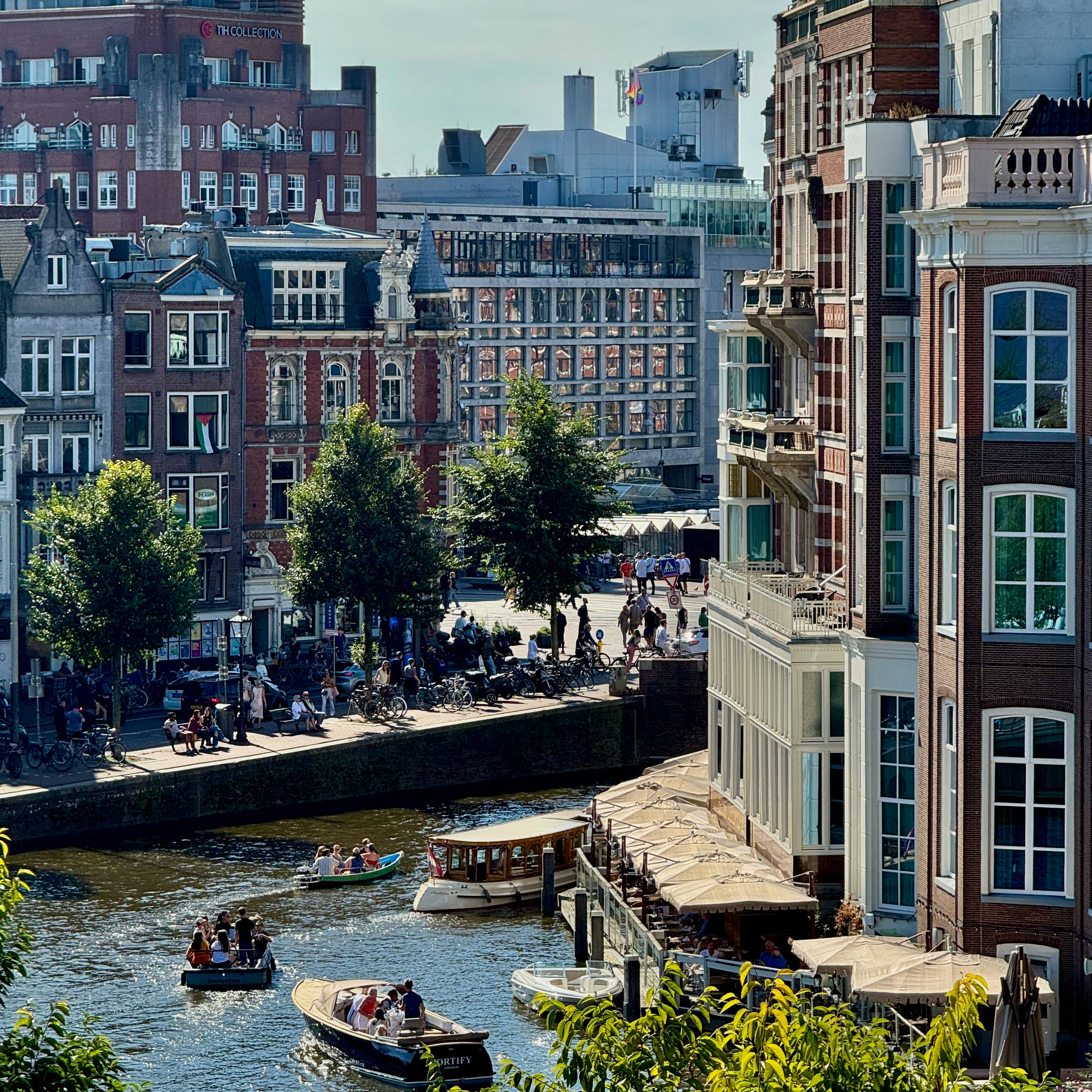 Boats on a canal in front of historic buildings