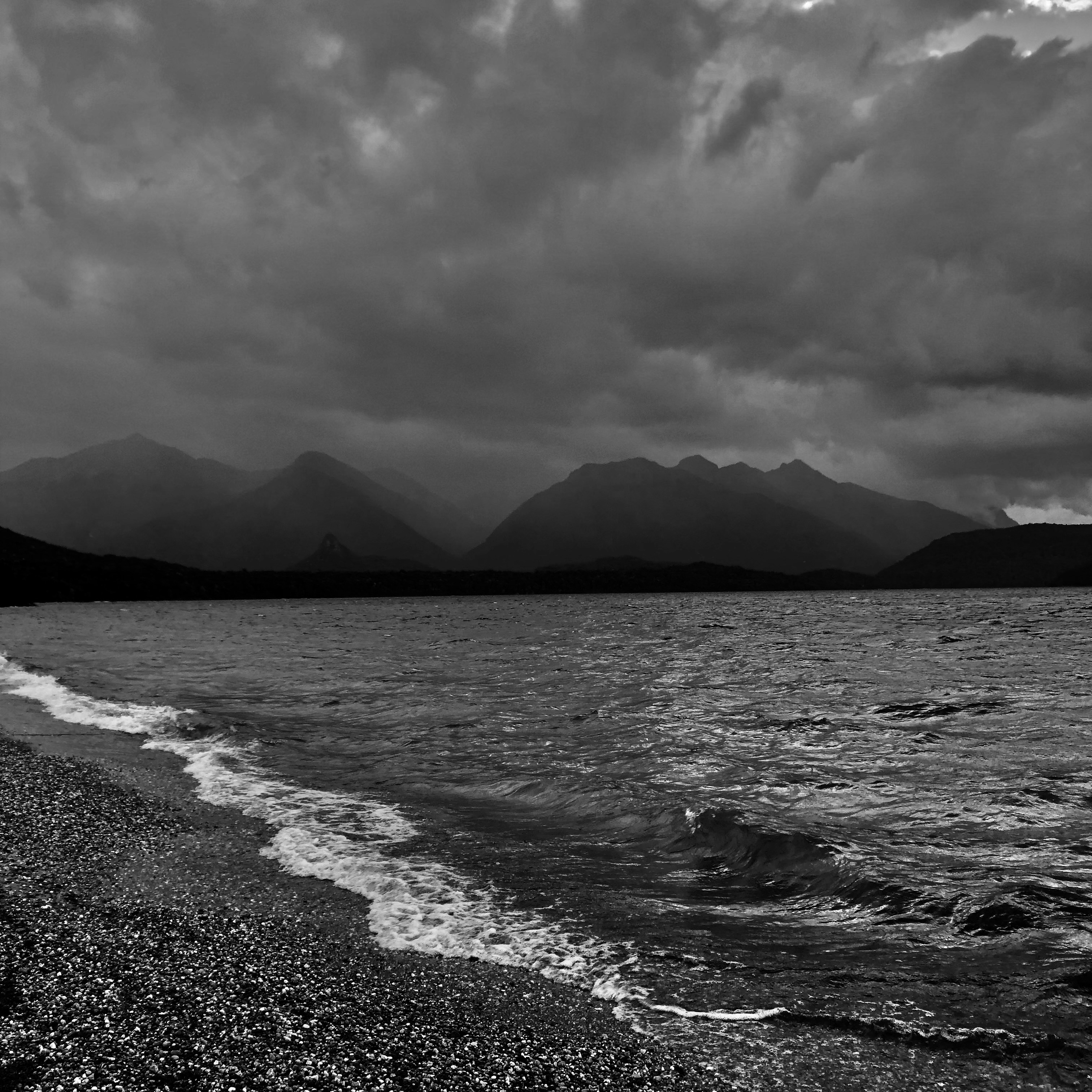 Stormy clouds over a lake and mountains