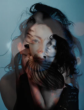 Double exposure of a woman's face with dark hair.