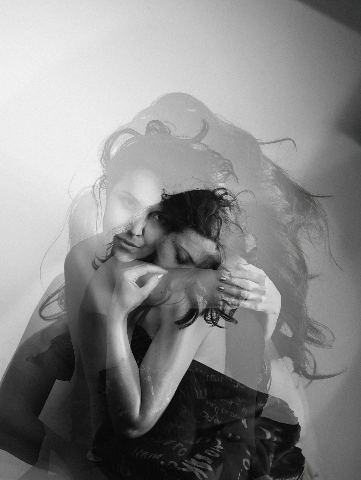 Double-exposure portrait of a woman embracing herself, self-compassion register