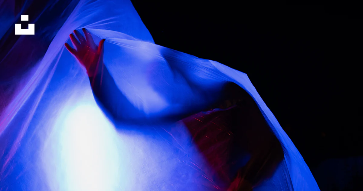 A person emerges from a blue, translucent fabric. photo – Free Abstract ...