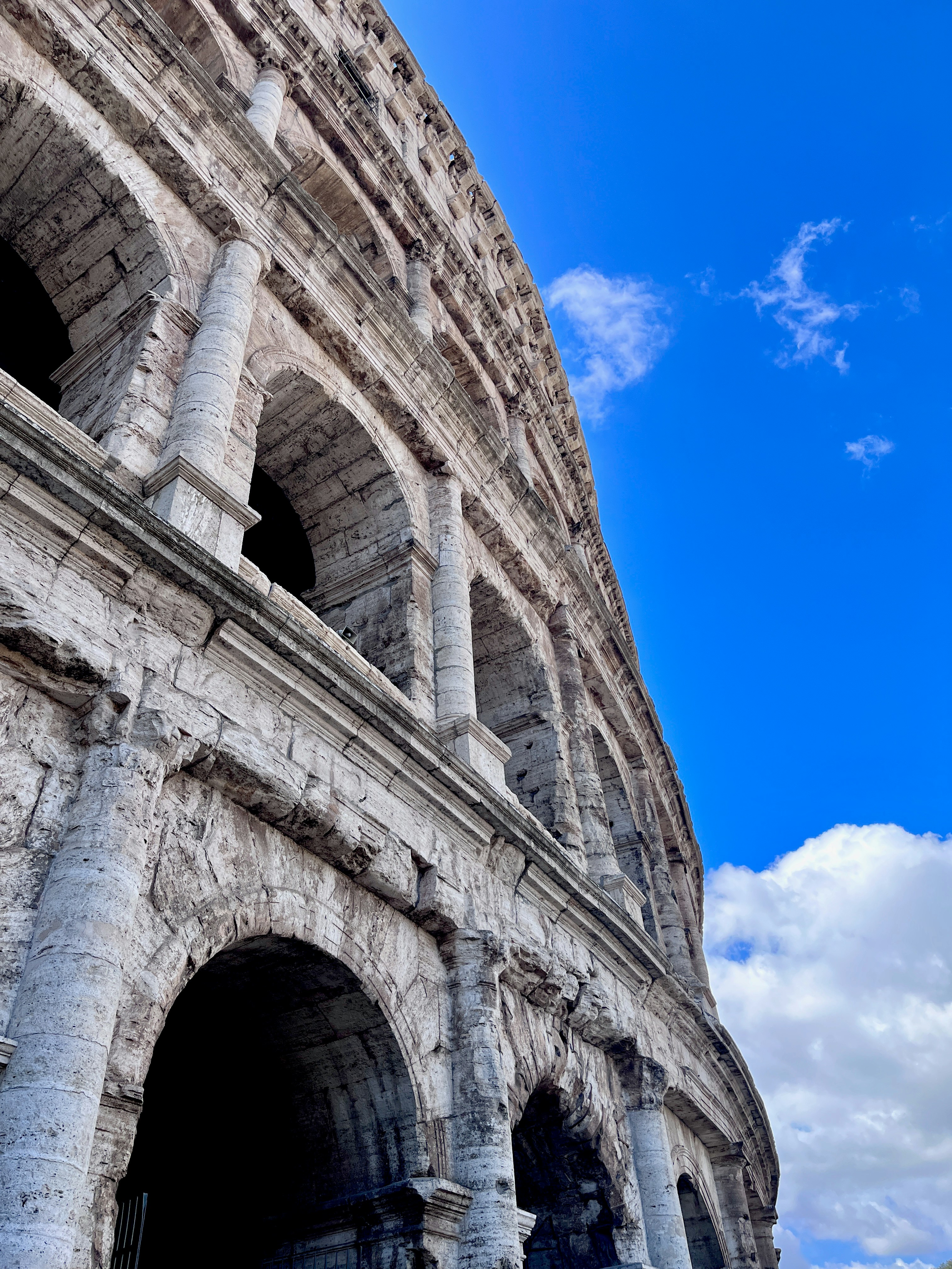 The colosseum under a bright blue sky