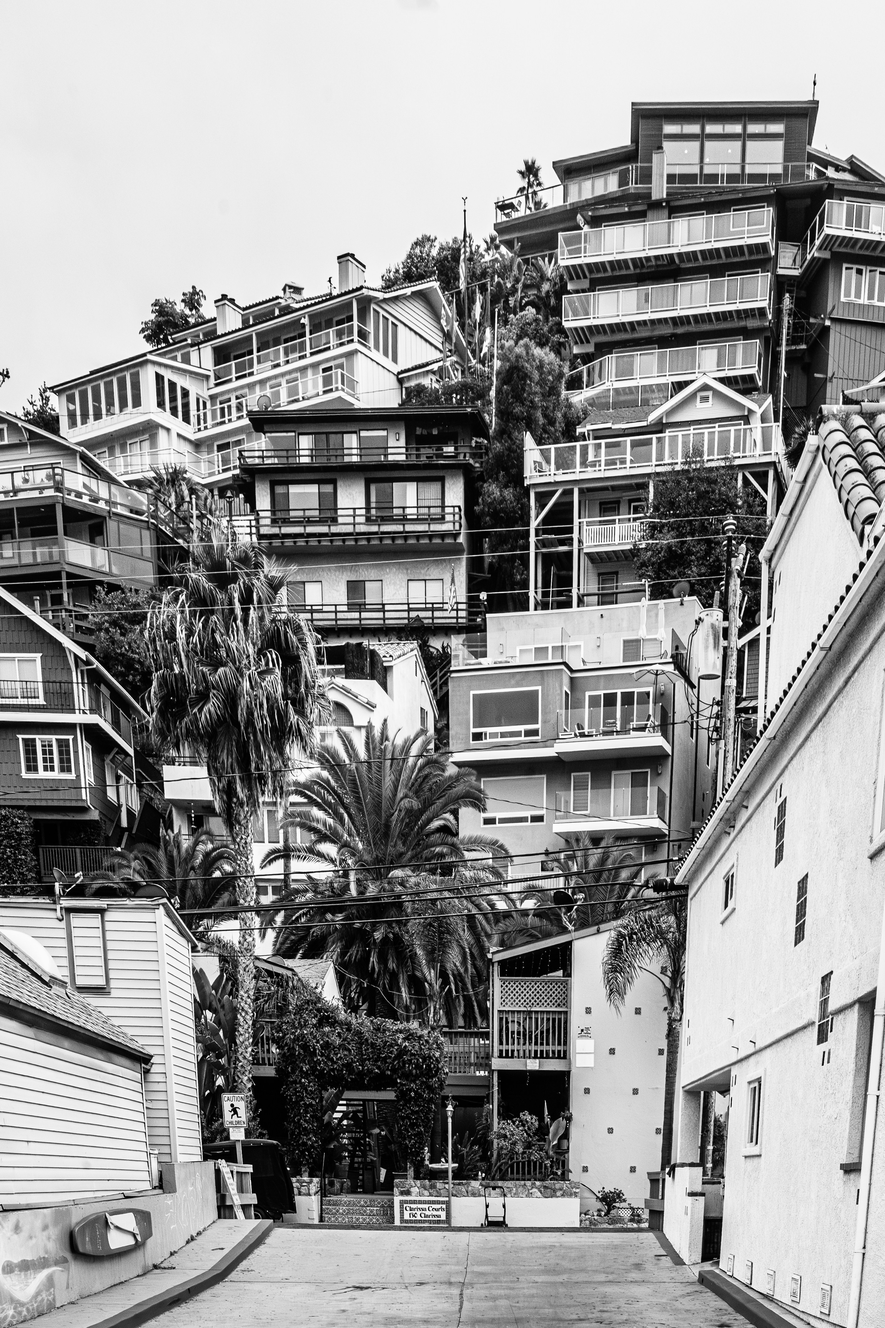 Houses built on a steep hillside overlooking the ocean.