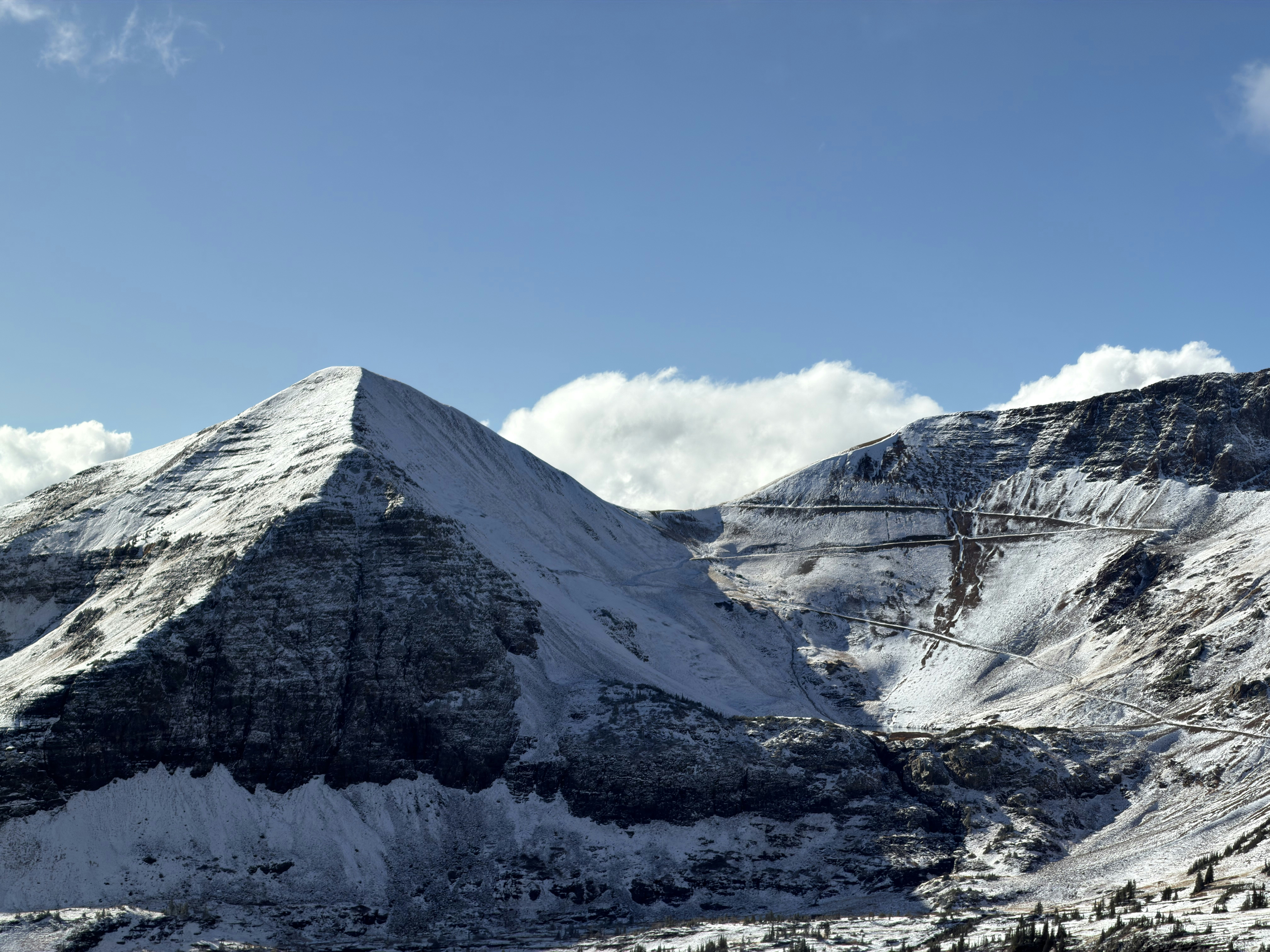 Snow-covered mountains under a clear blue sky.
