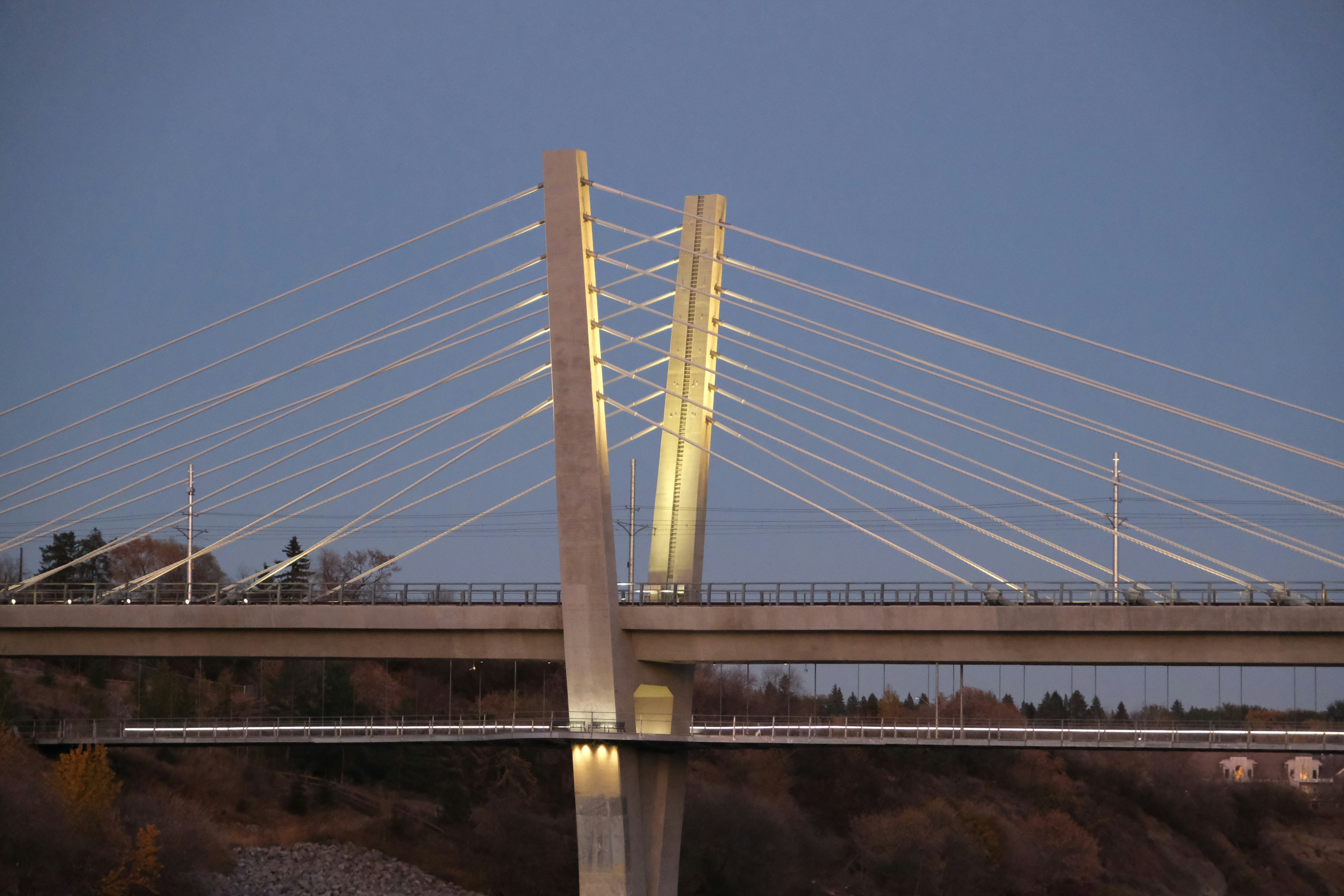 Modern cable-stayed bridge illuminated at dusk