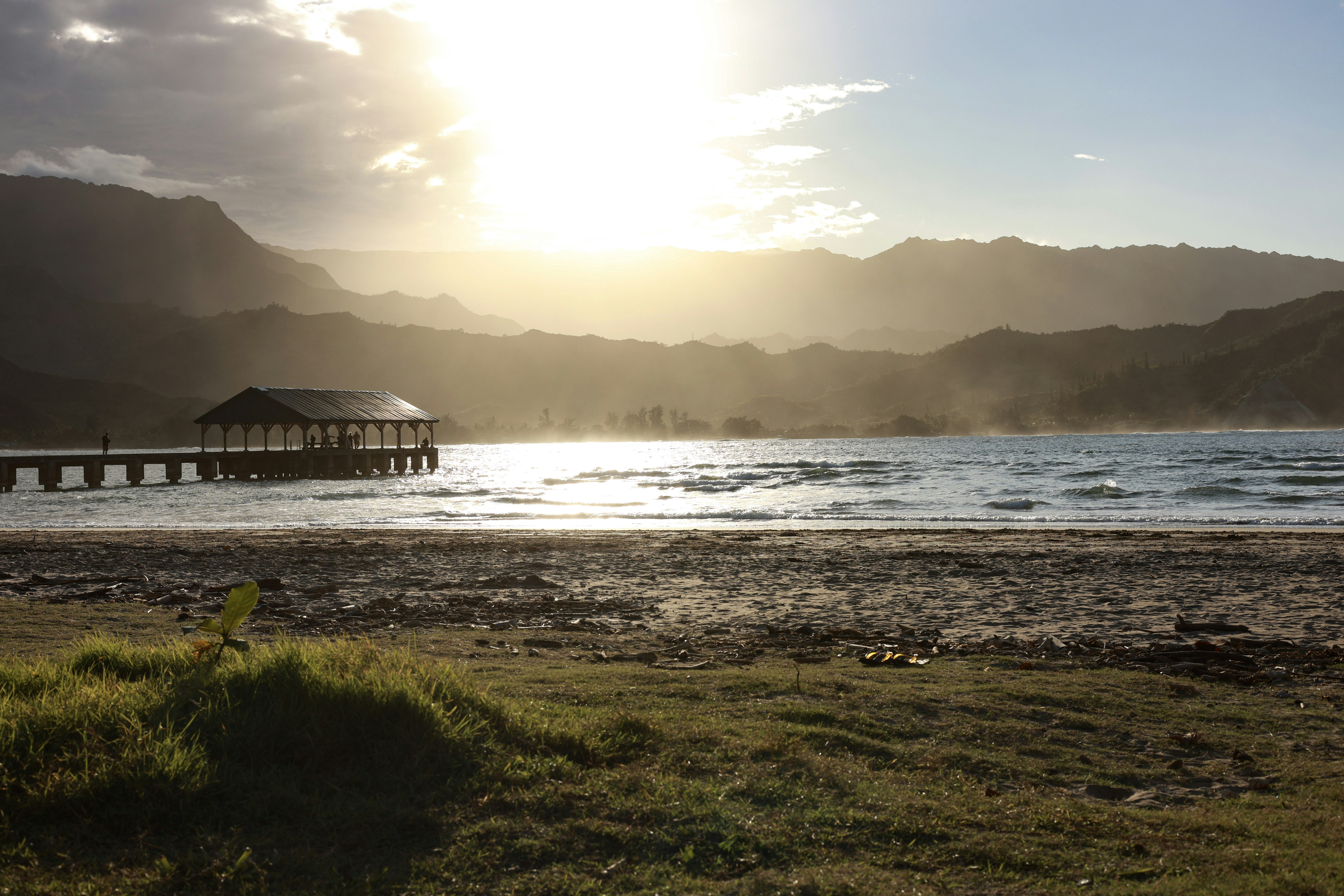Pier extending into the ocean at sunset