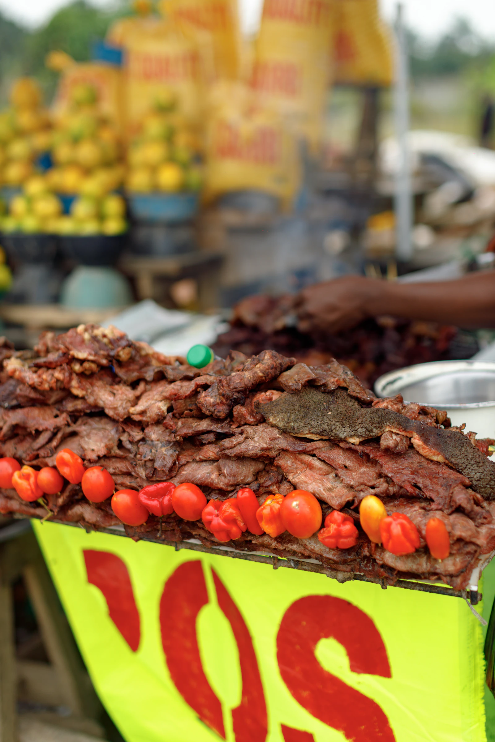 Smoked meat and peppers at a street food stall