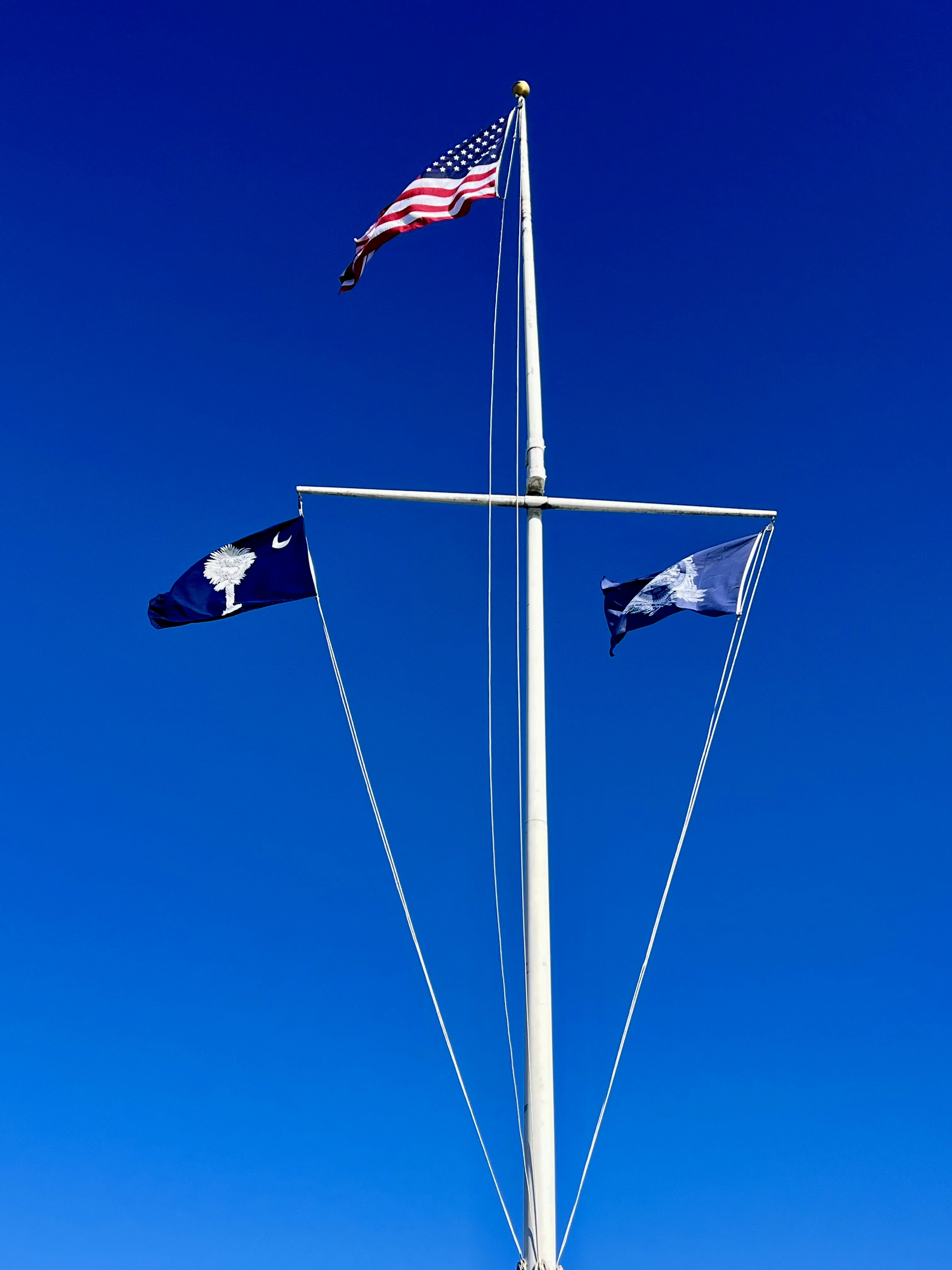 American and south carolina flags on flagpole