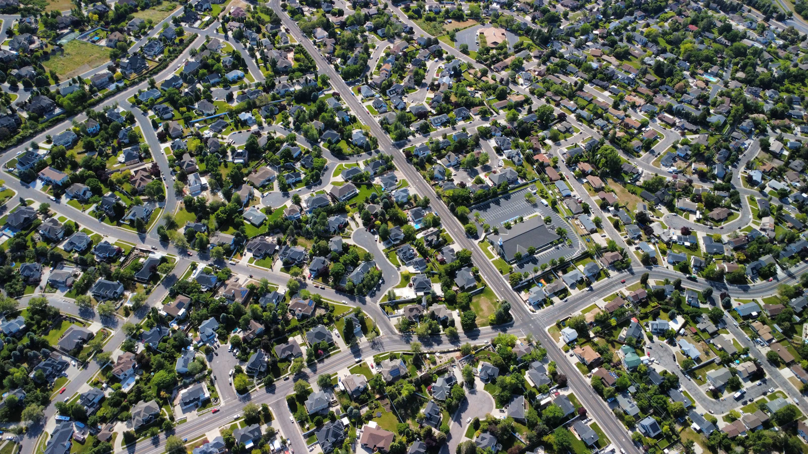 Aerial view of a Far North Dallas suburban neighborhood with shingled roofs