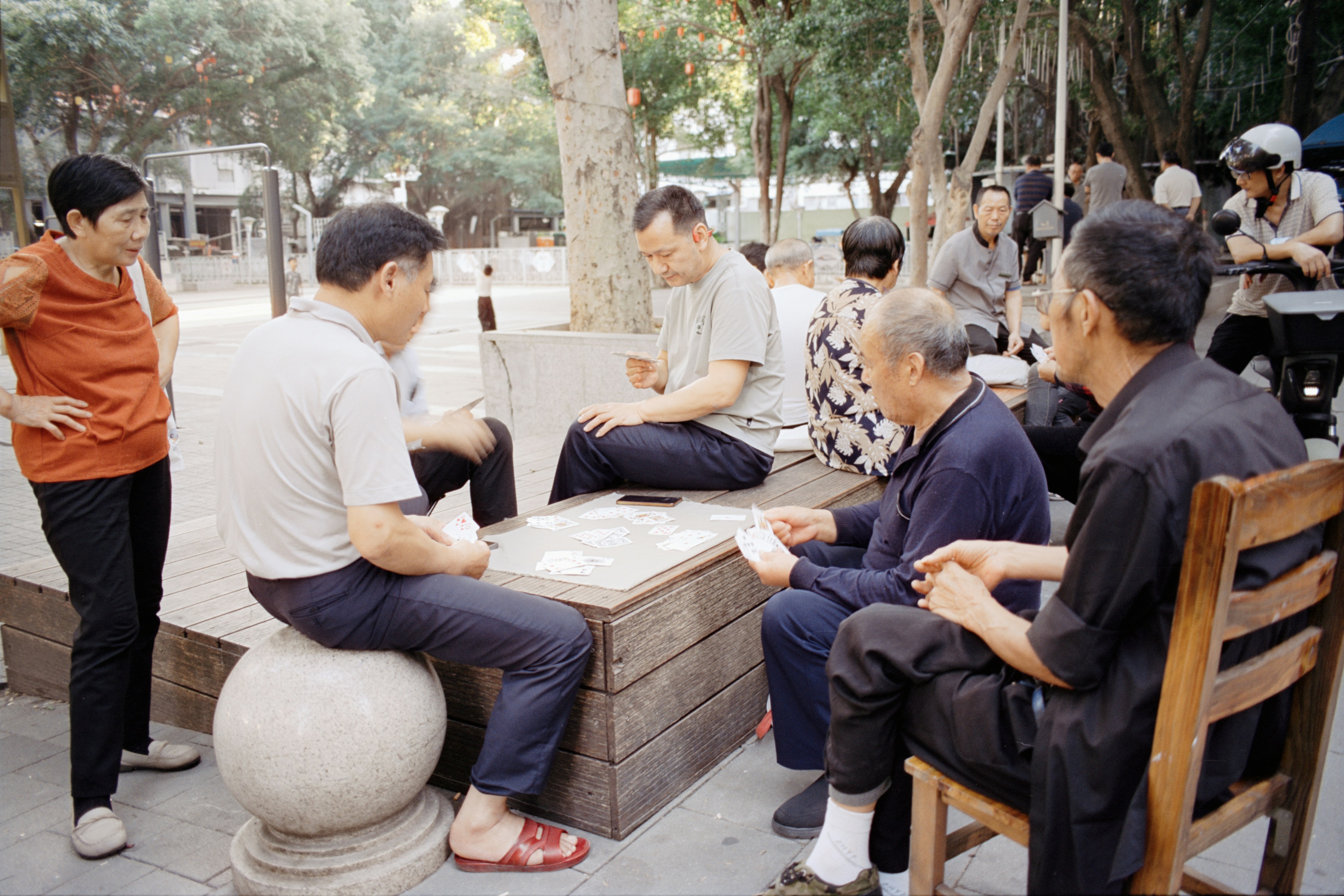 Elderly people playing a board game outdoors