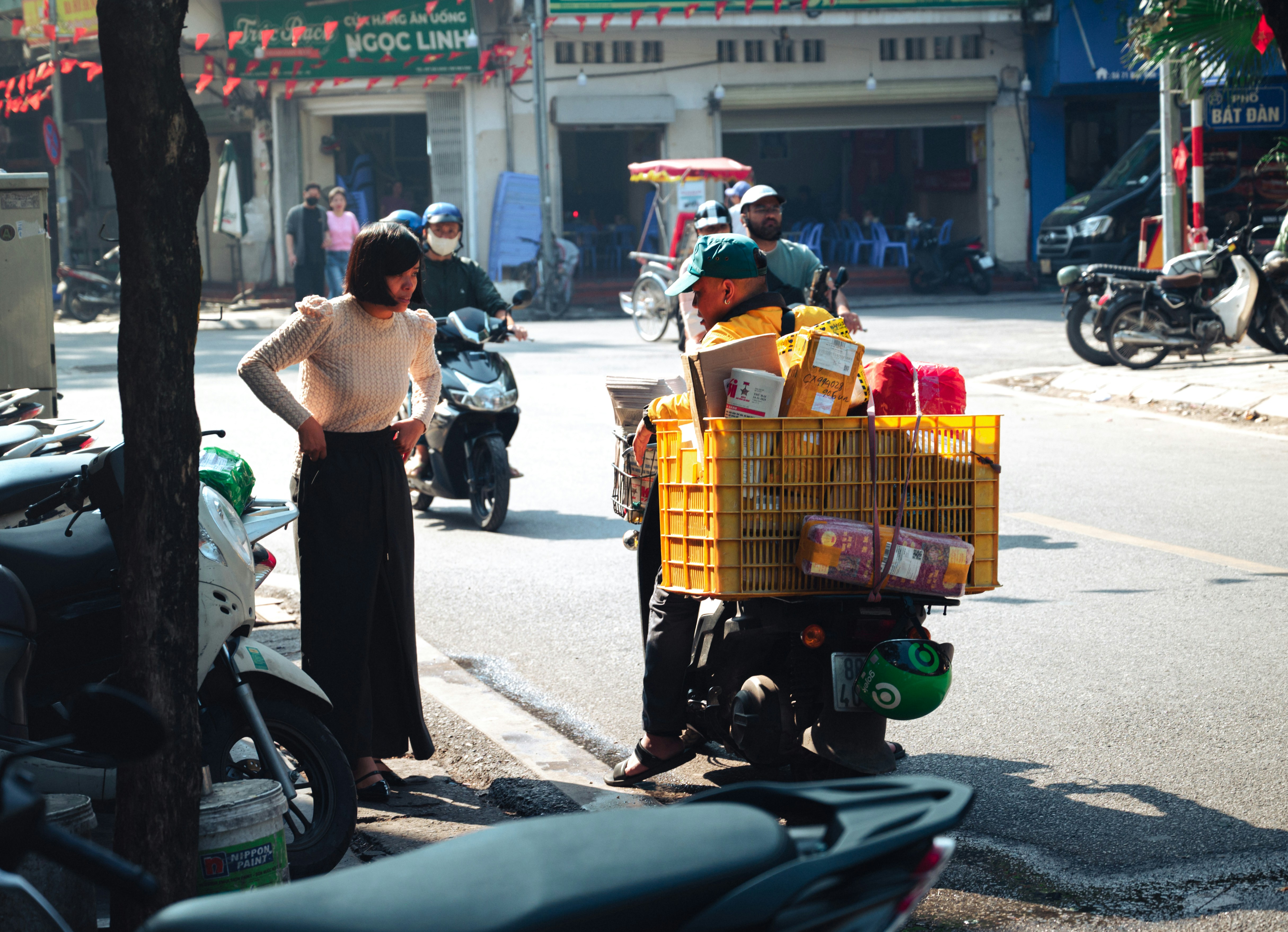 Delivery person with packages on a scooter
