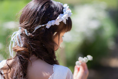 Woman with flower crown holding small white flowers