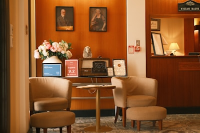 Two armchairs and a table in a hotel lobby.