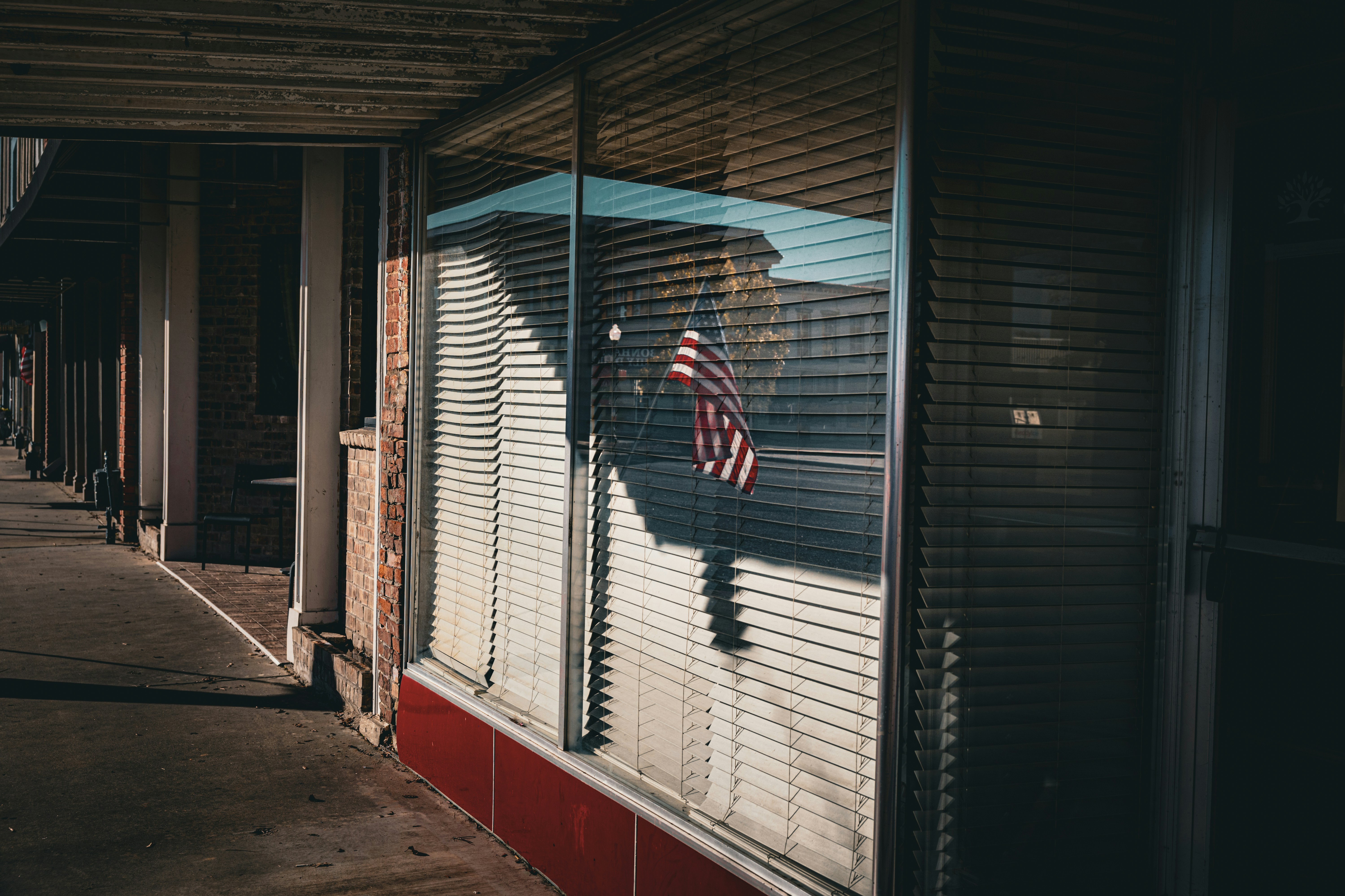 American flag reflected in a storefront window
