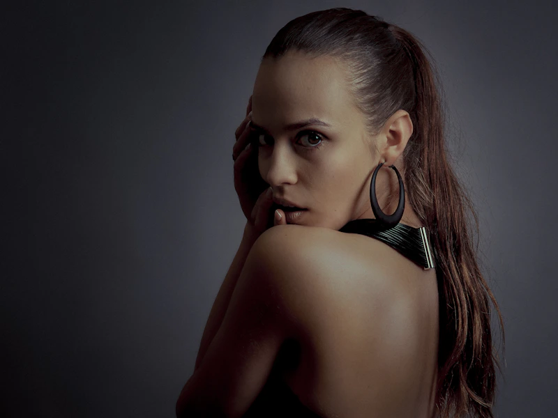 Stylish sugar baby with dark hair and hoop earrings, a trendy match for an Australian sugar daddy