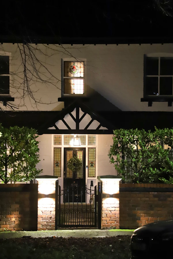 Front entrance decorated with holiday lights and a lit wreath