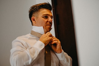 Man adjusting his tie and collar
