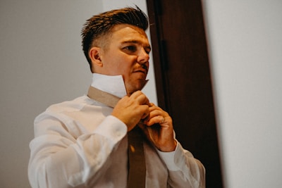 Man adjusting his tie and collar
