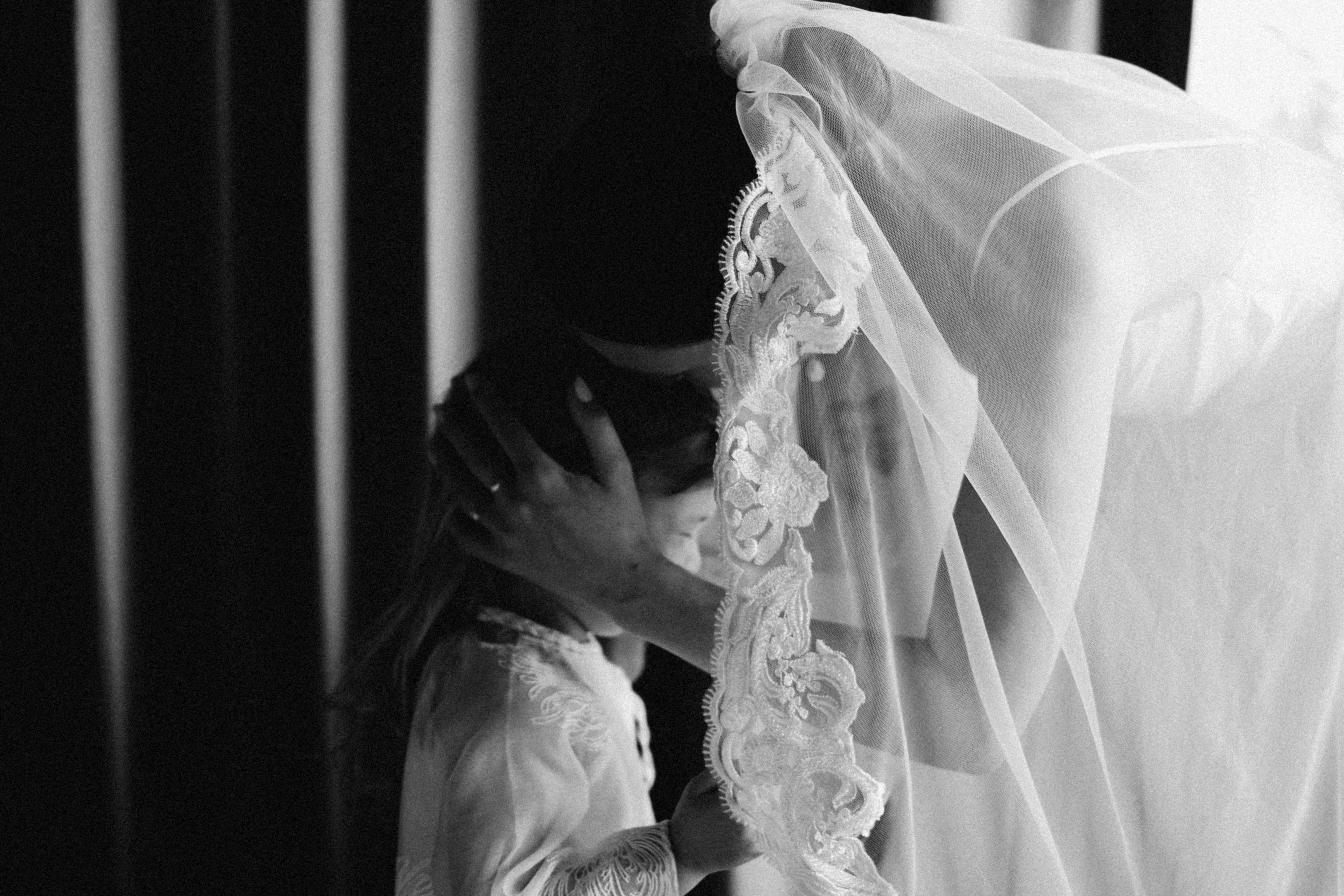 Bride comforting a child under veil