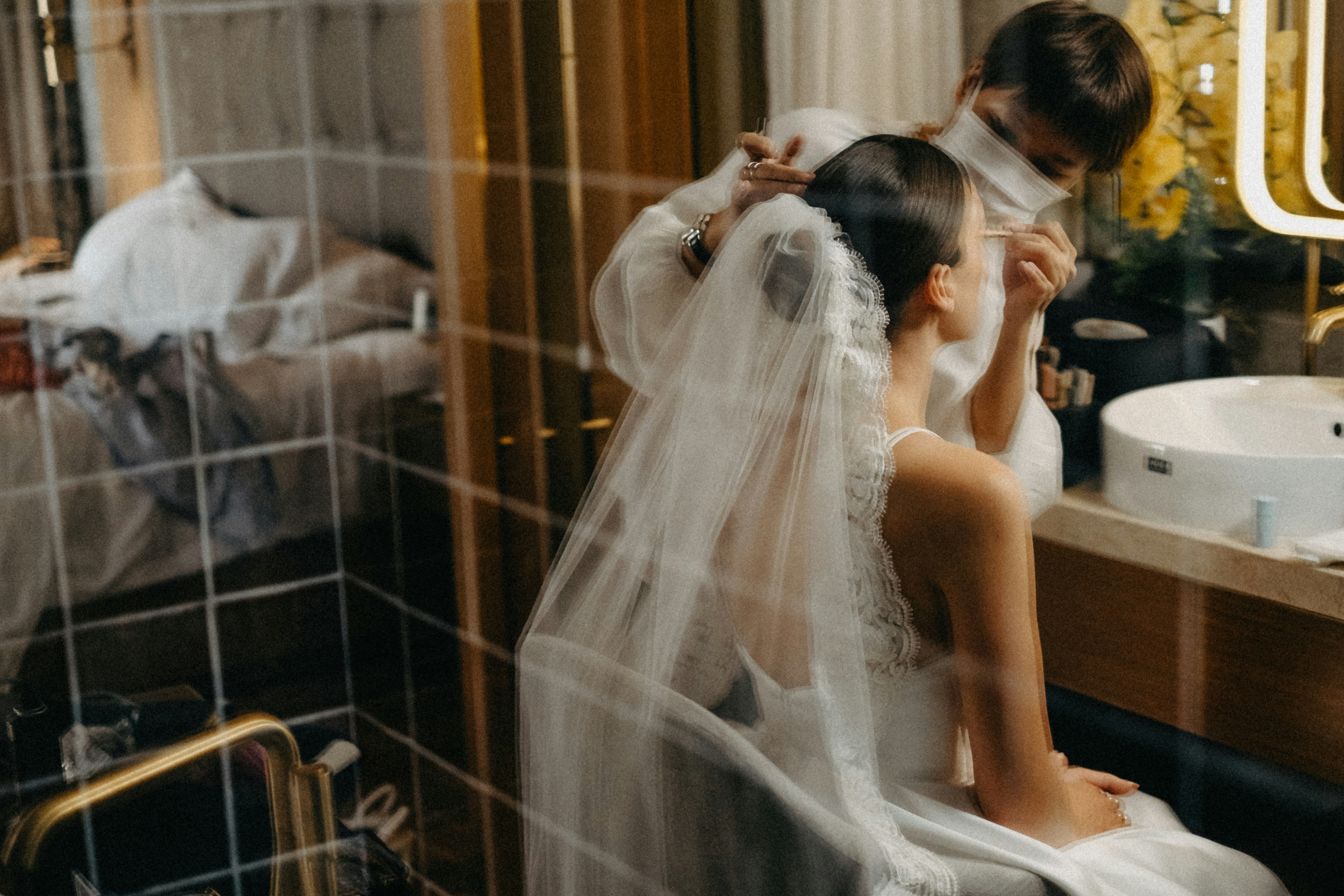 Bride getting hair styled before wedding ceremony