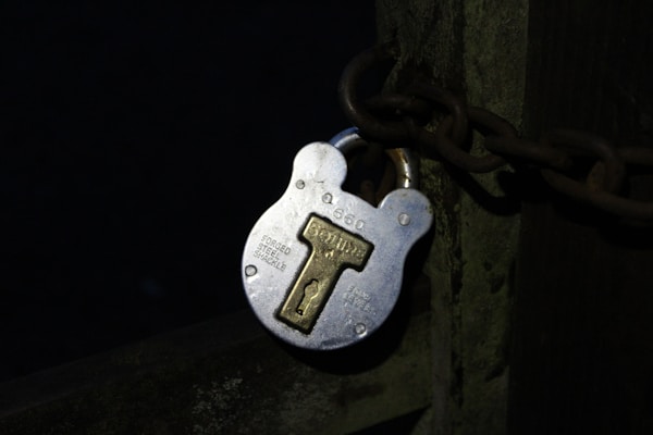 Vintage padlock on a rusty chain, symbolizing the false security many gold scam victims experience