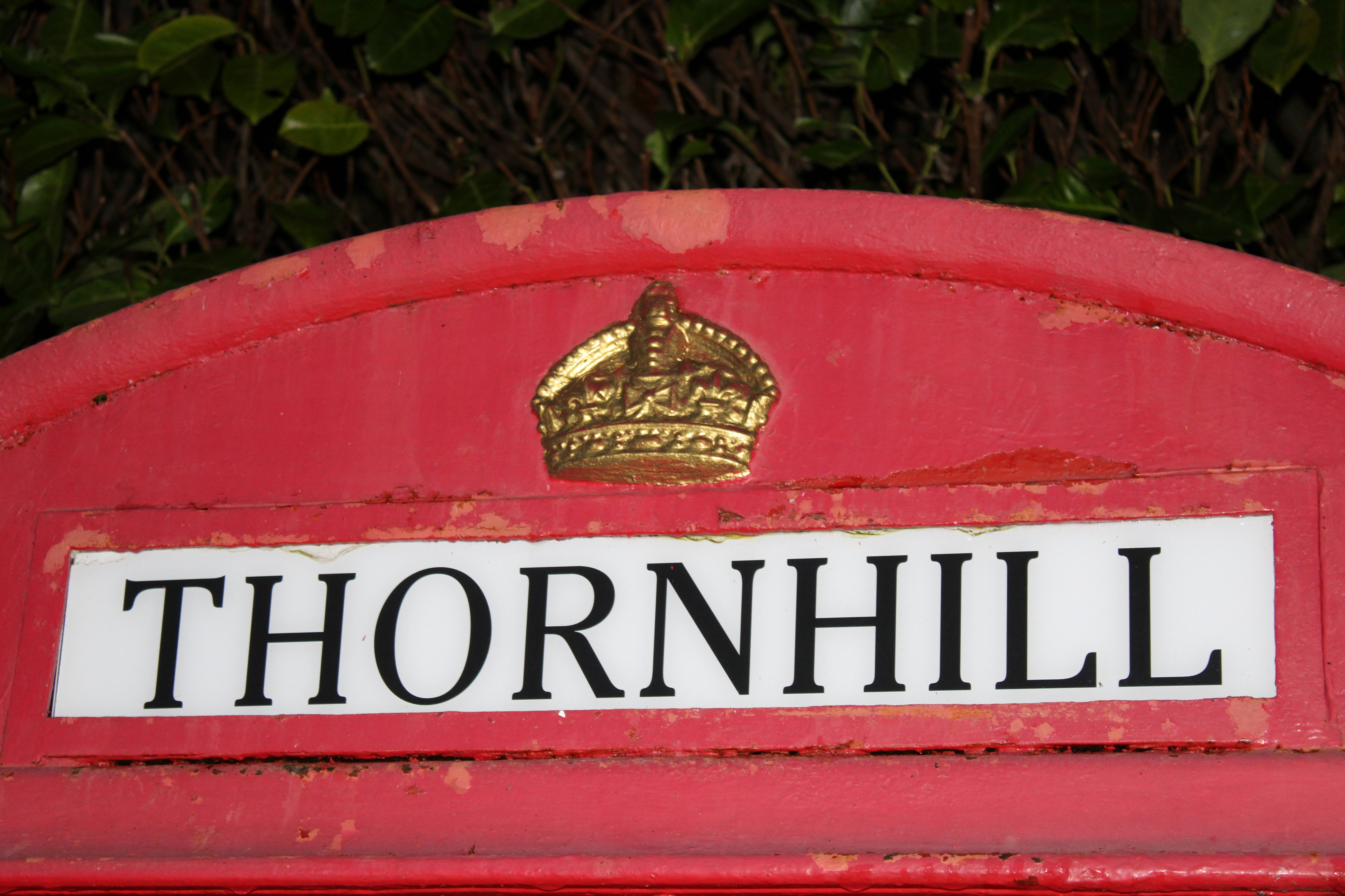 A red telephone box with the name thornhill.