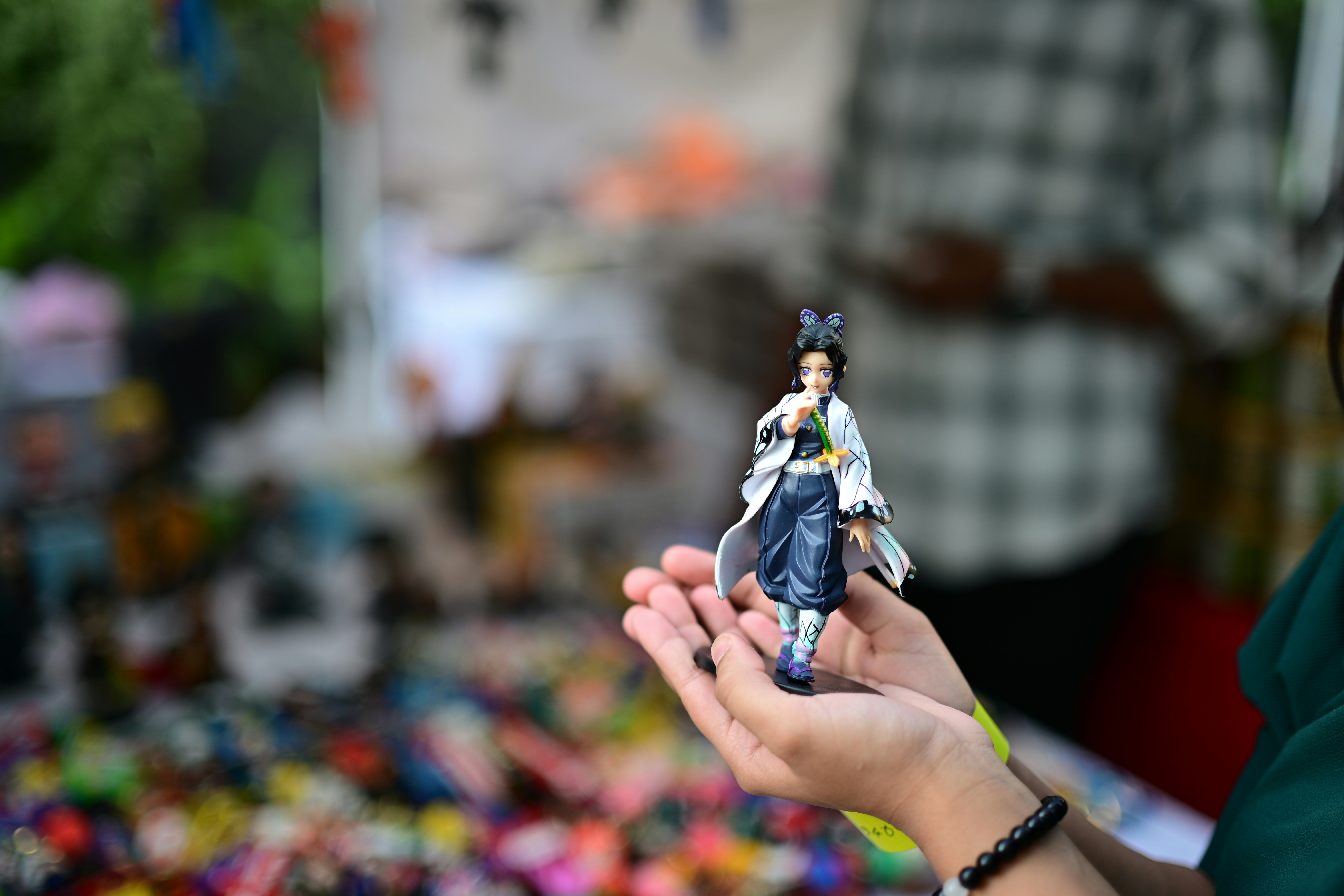 Person holding a small figurine in hands