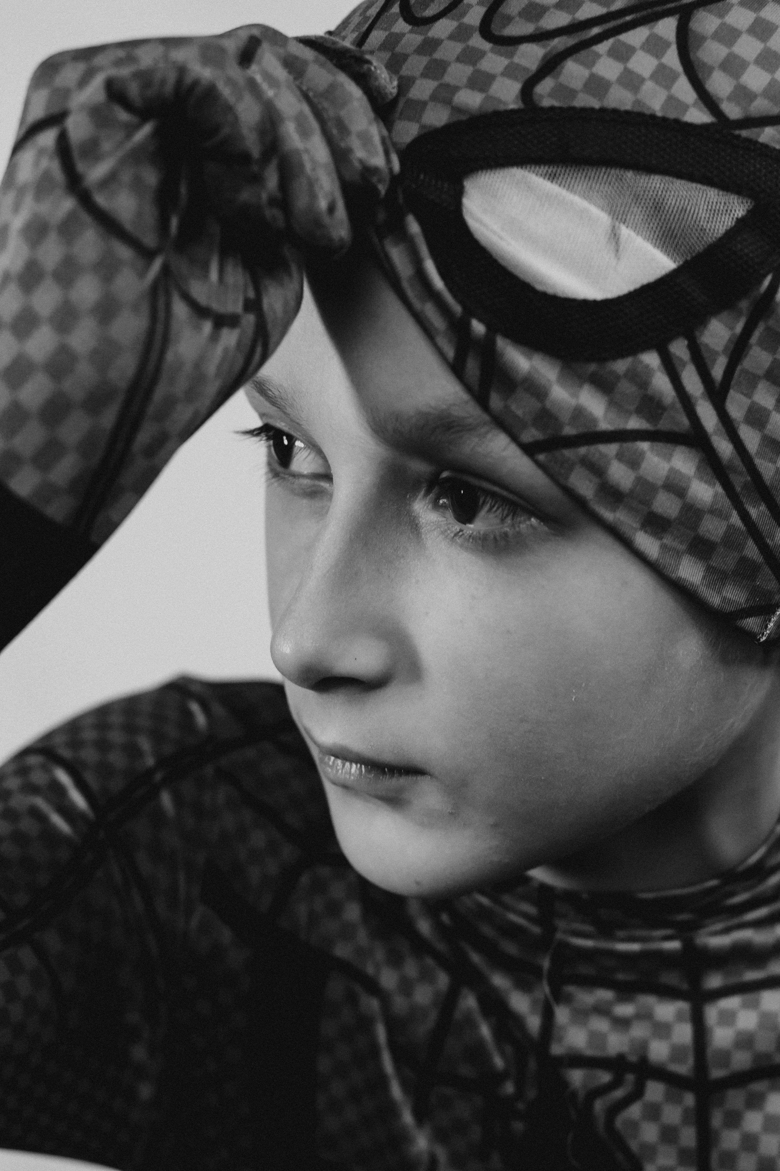 Young boy wearing a superhero costume