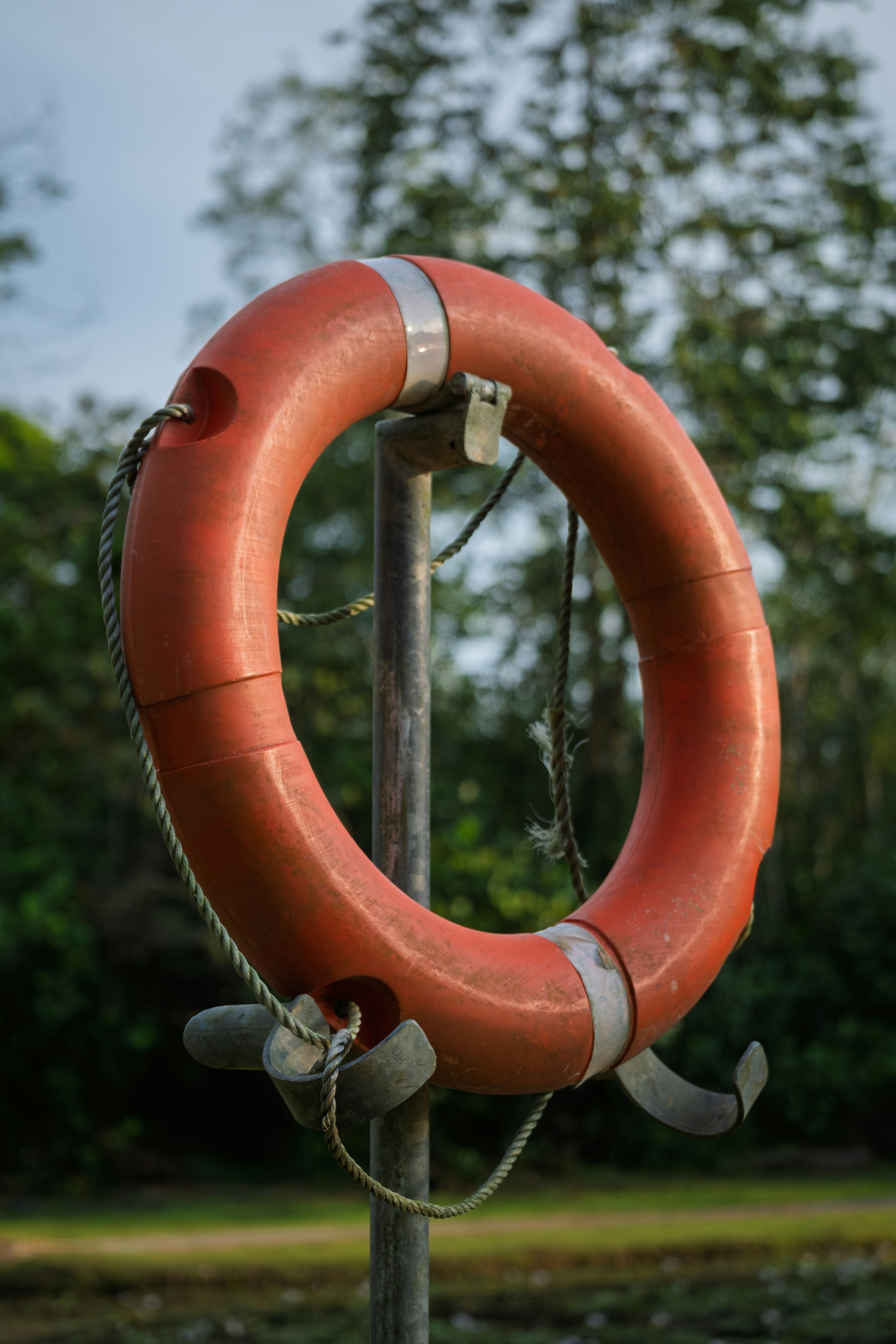 Orange life preserver ring hanging on pole
