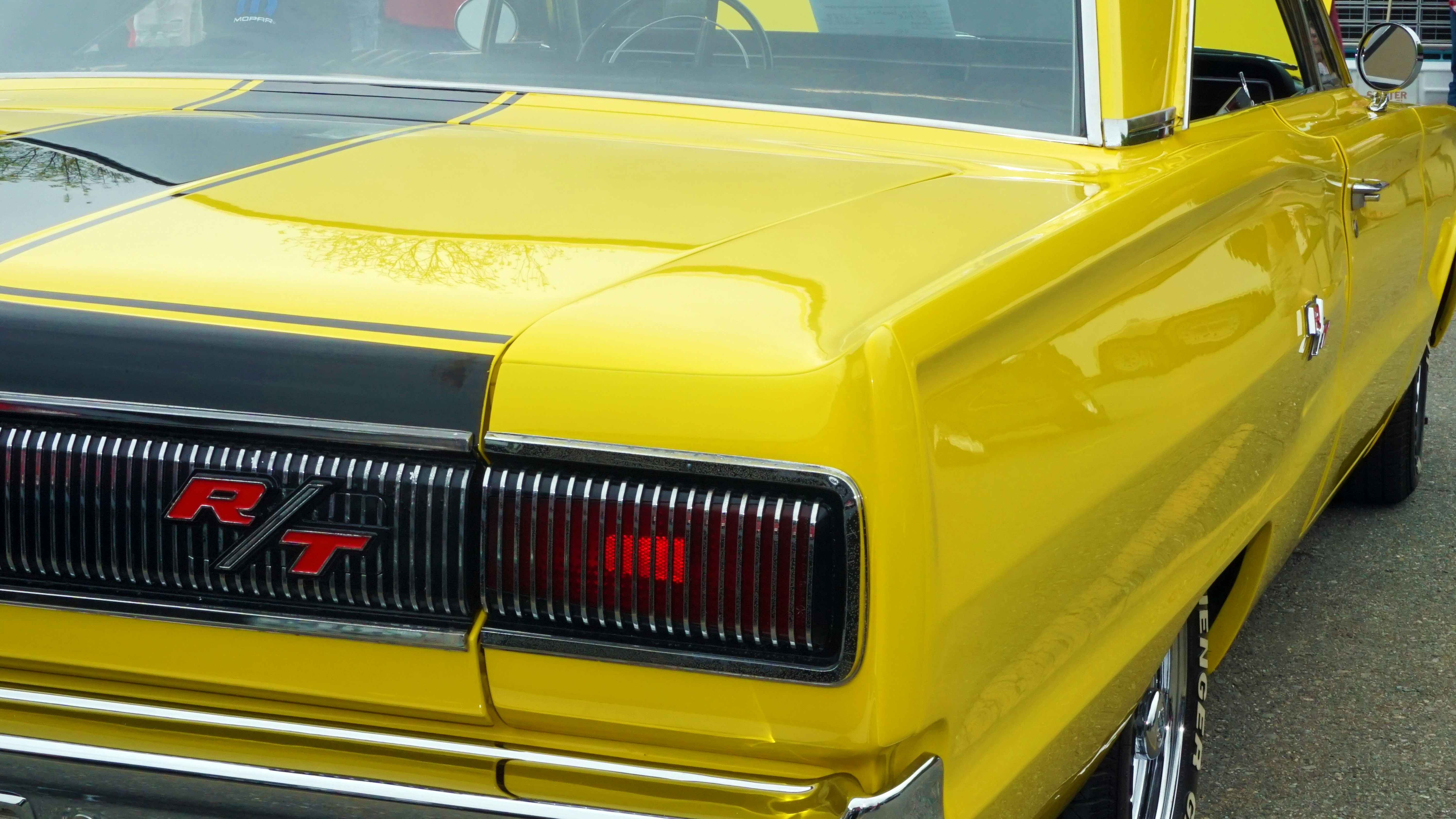 Yellow classic car with black racing stripes