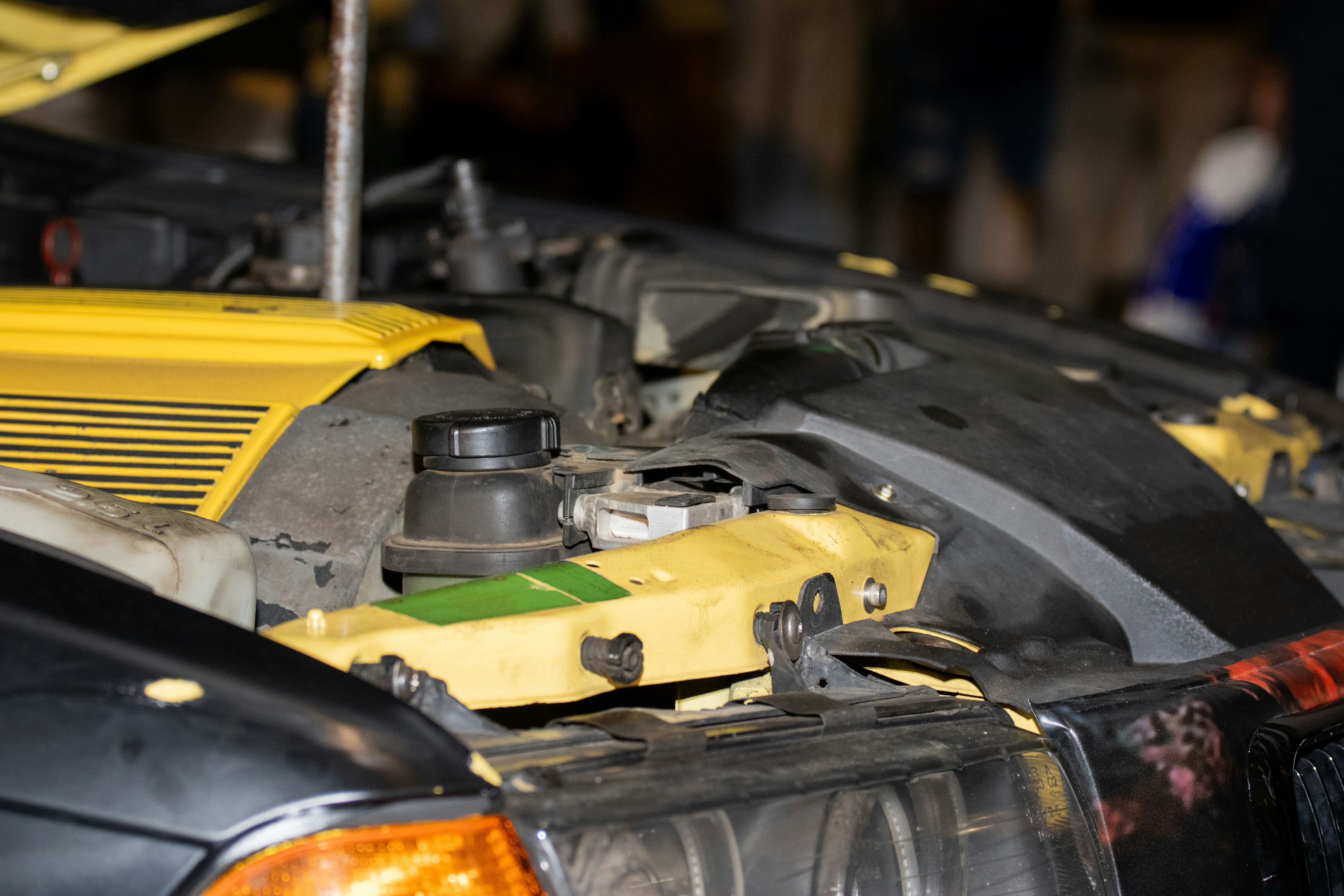 Close-up of a car engine with yellow accents.