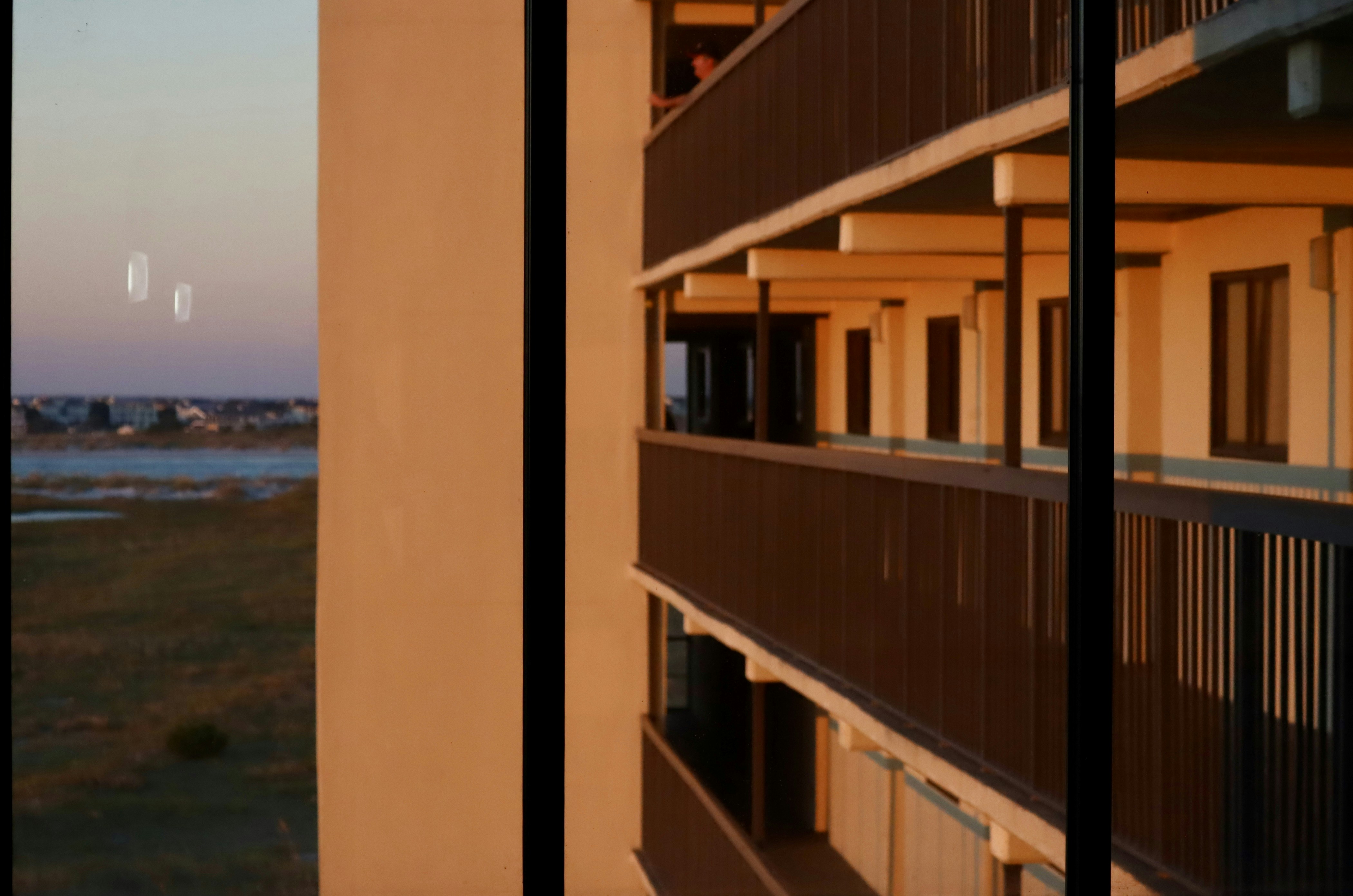 Balconies of a building with ocean view at sunset