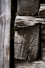 Close-up of weathered wooden logs stacked together