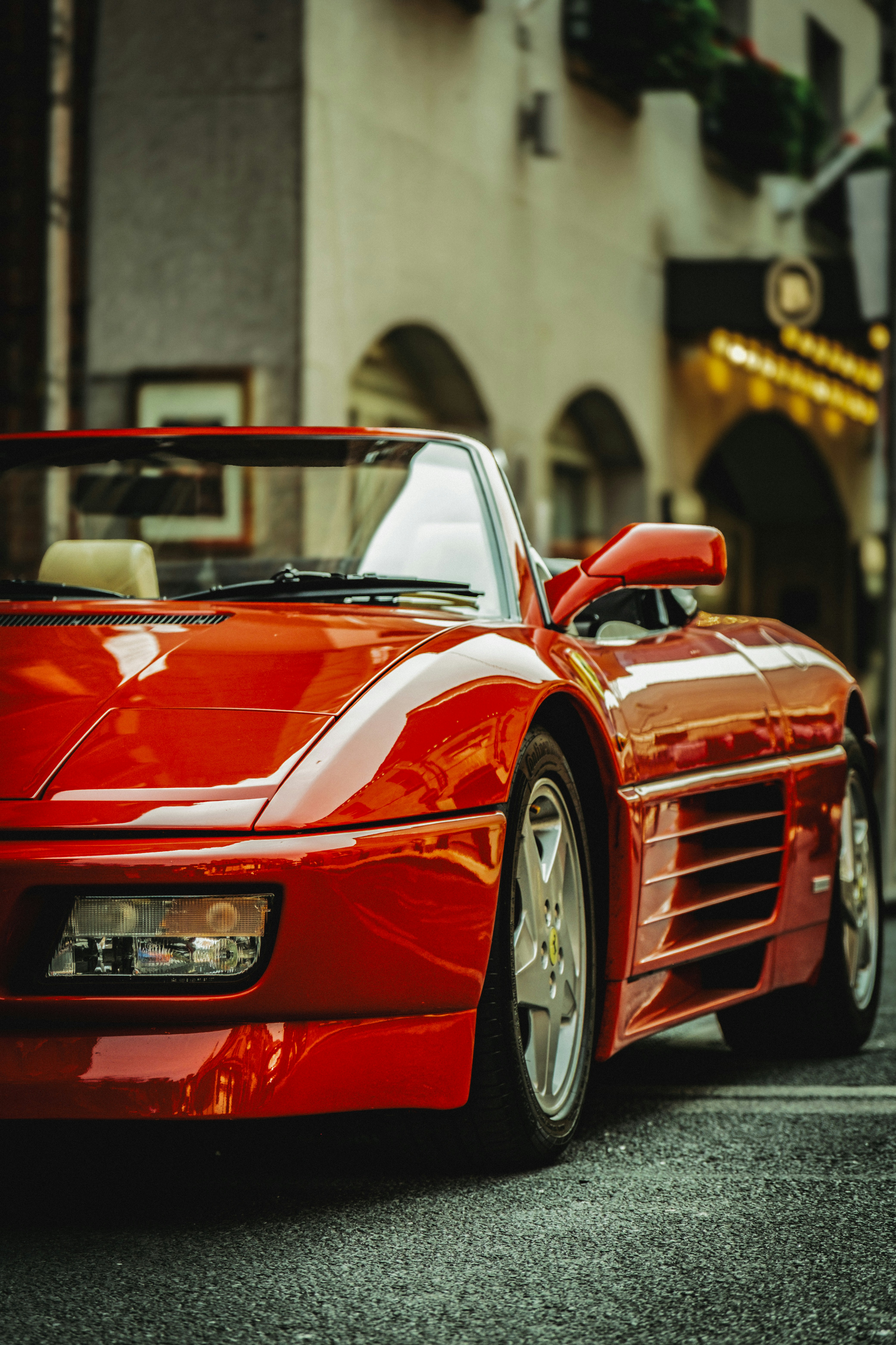 A red convertible sports car parked on a street.