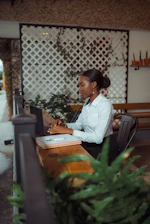 A woman typing on a laptop at a desk.