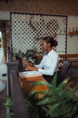 A woman typing on a laptop at a desk.