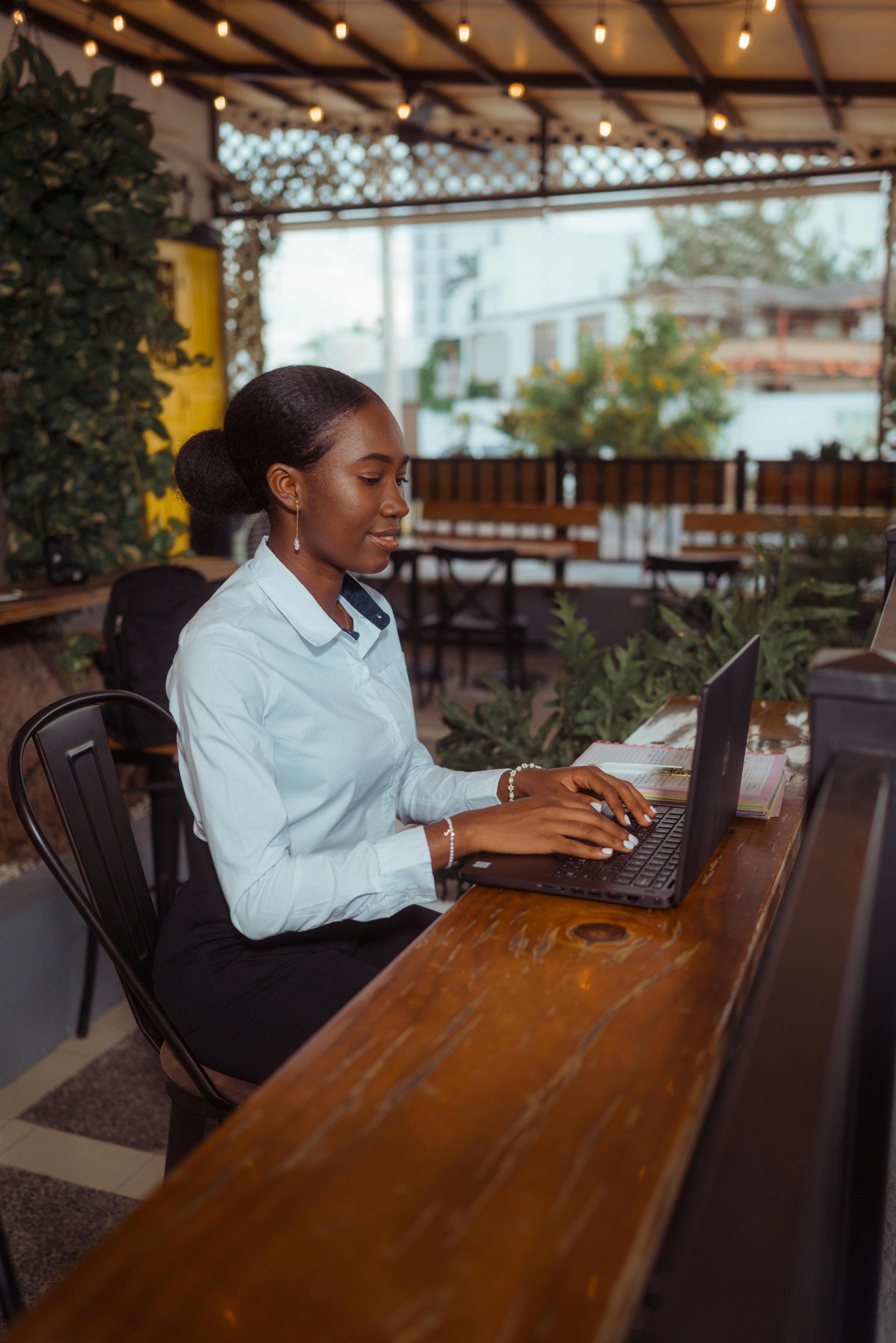 Women journaling at a European cafe while planning a personalized travel itinerary.
