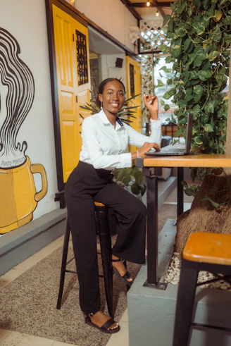 Young woman working on laptop at a cafe