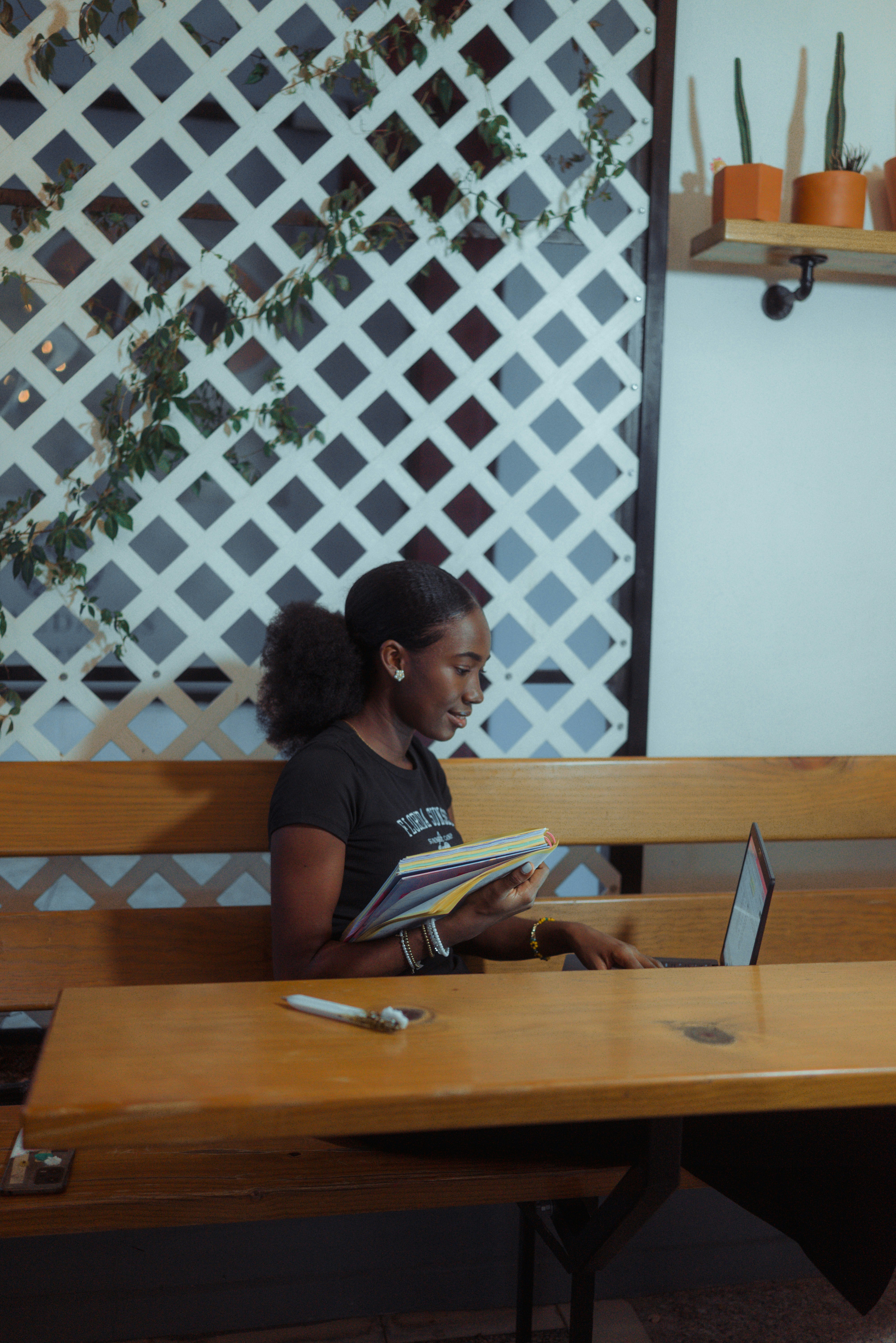 Person planning a portfolio of work with a notebook and laptop