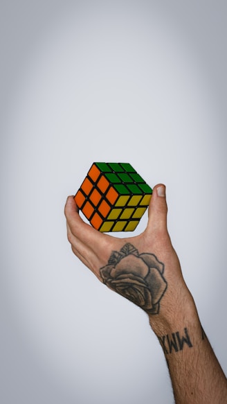 Hand holding a colorful rubik's cube puzzle