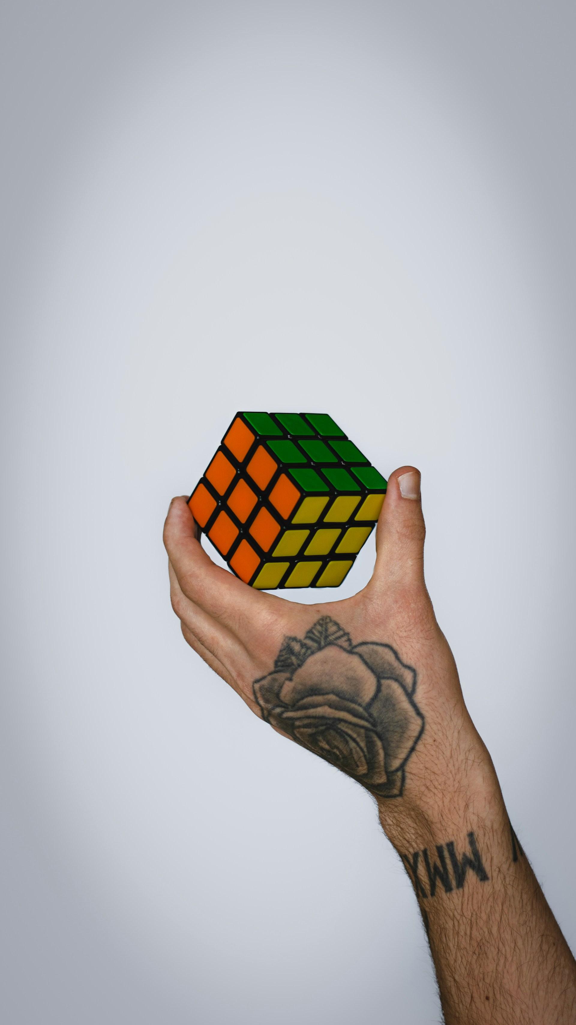 Hand holding a colorful rubik's cube puzzle