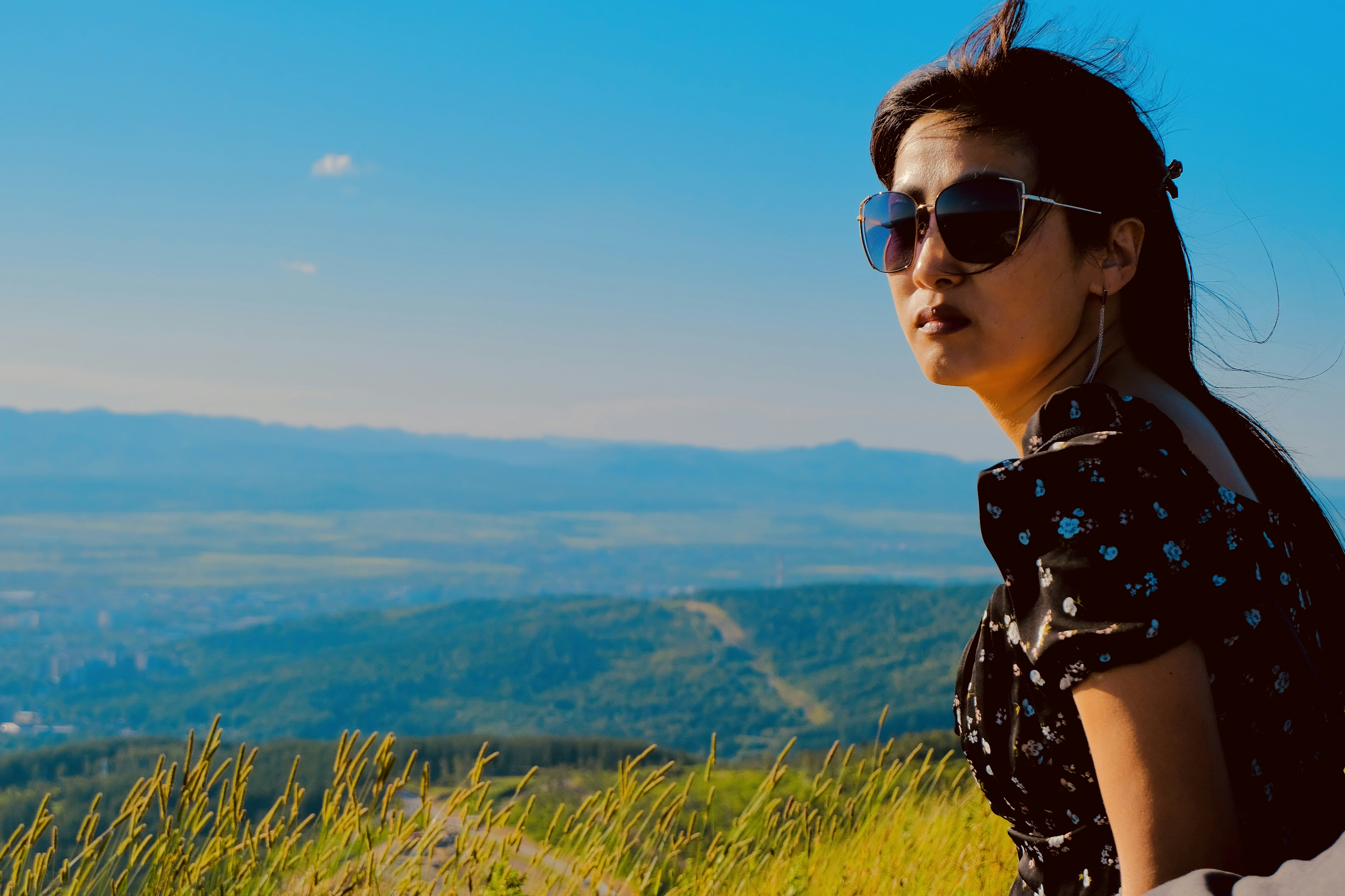 Woman in sunglasses looking out over a landscape
