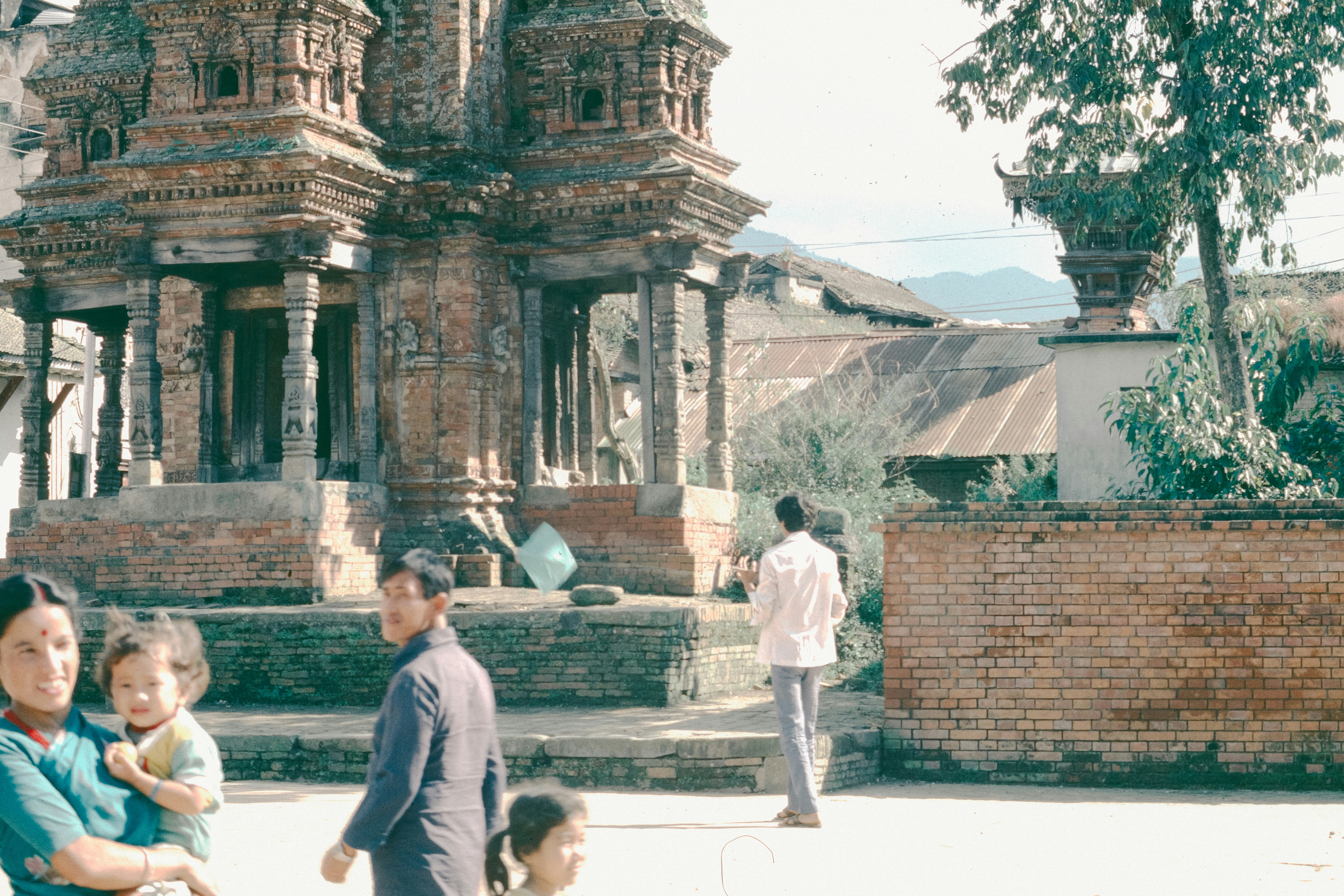 People near ancient brick temple structures