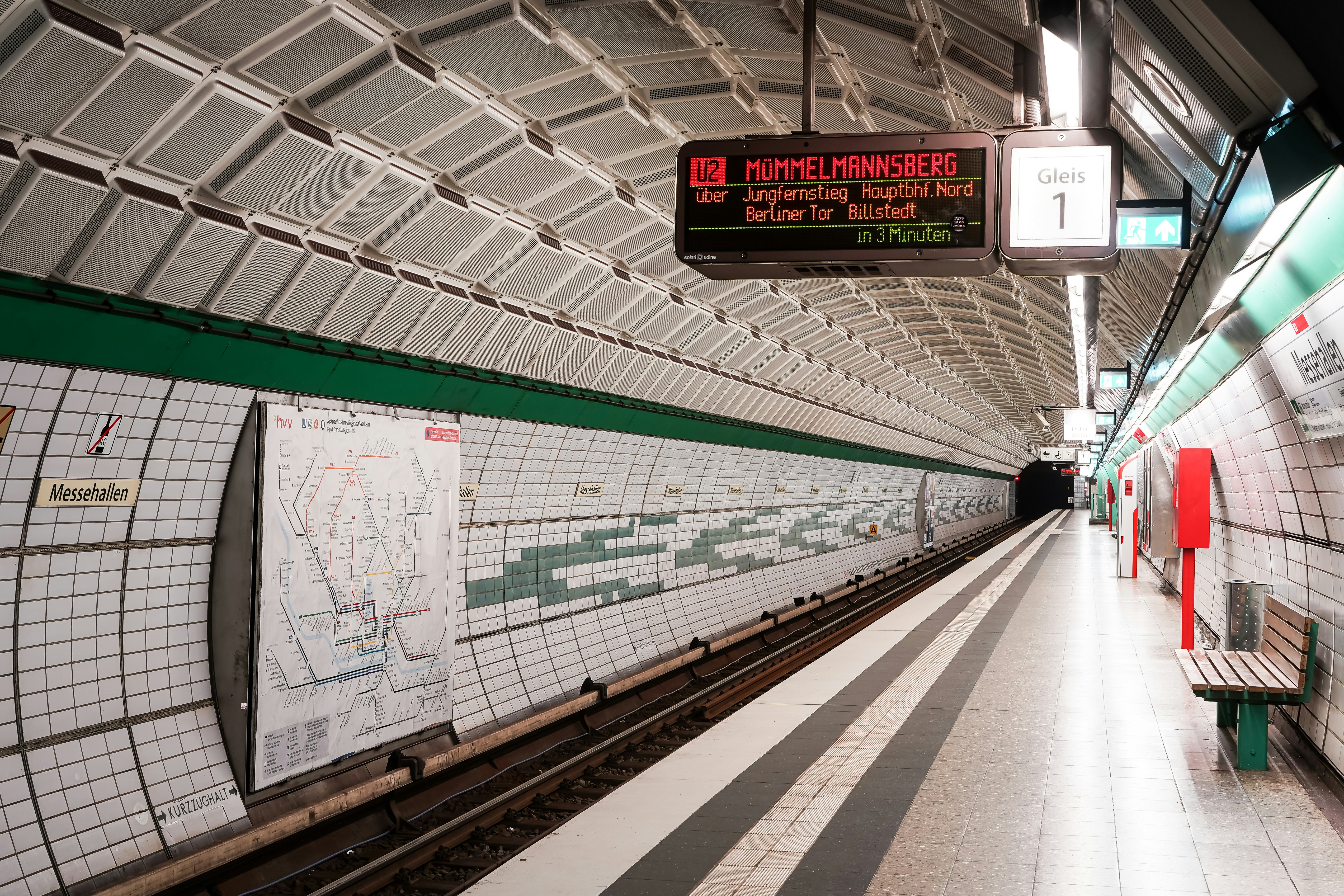 Empty subway station platform with train tracks.