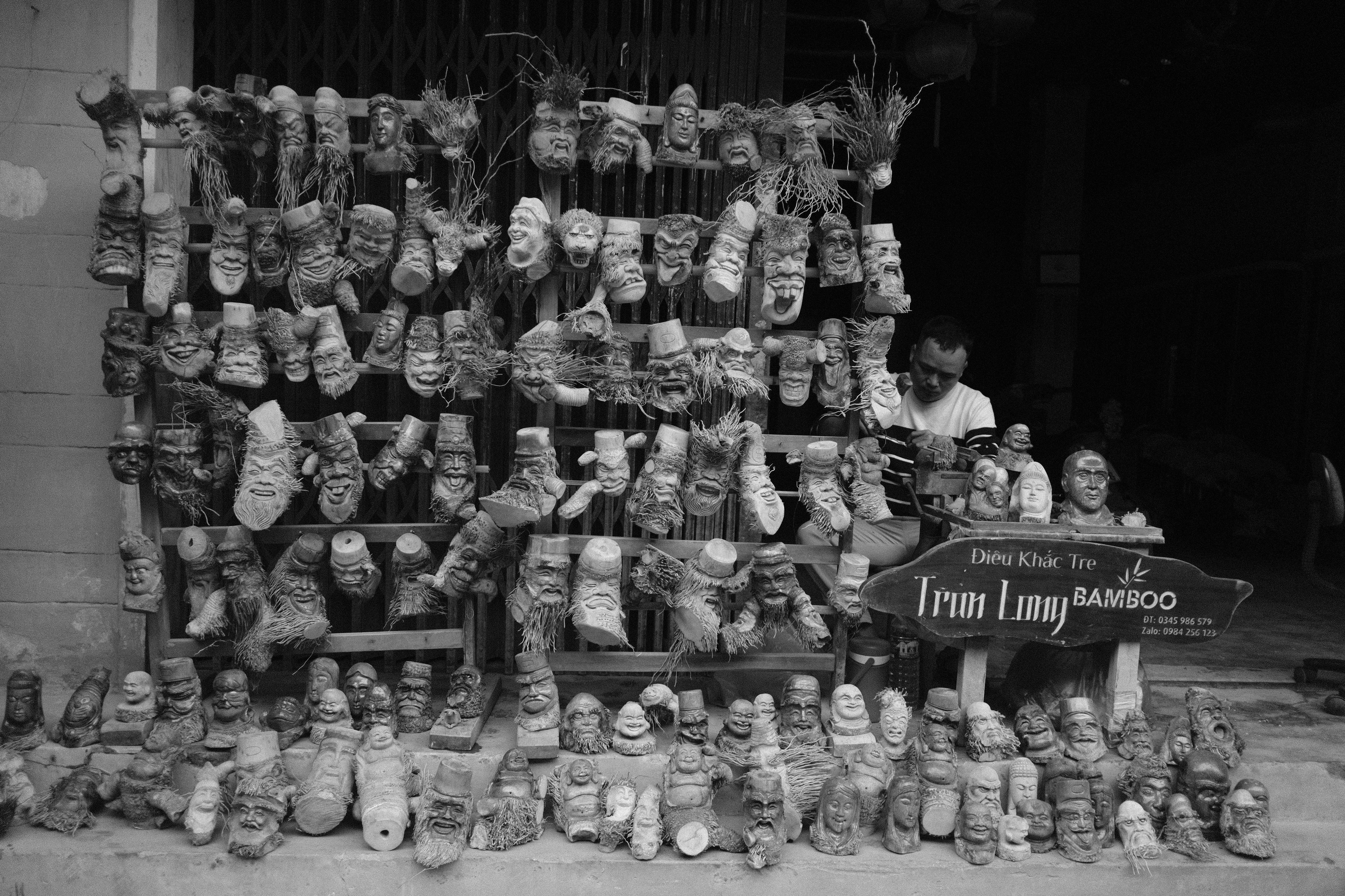 Man behind stall selling bamboo crafts