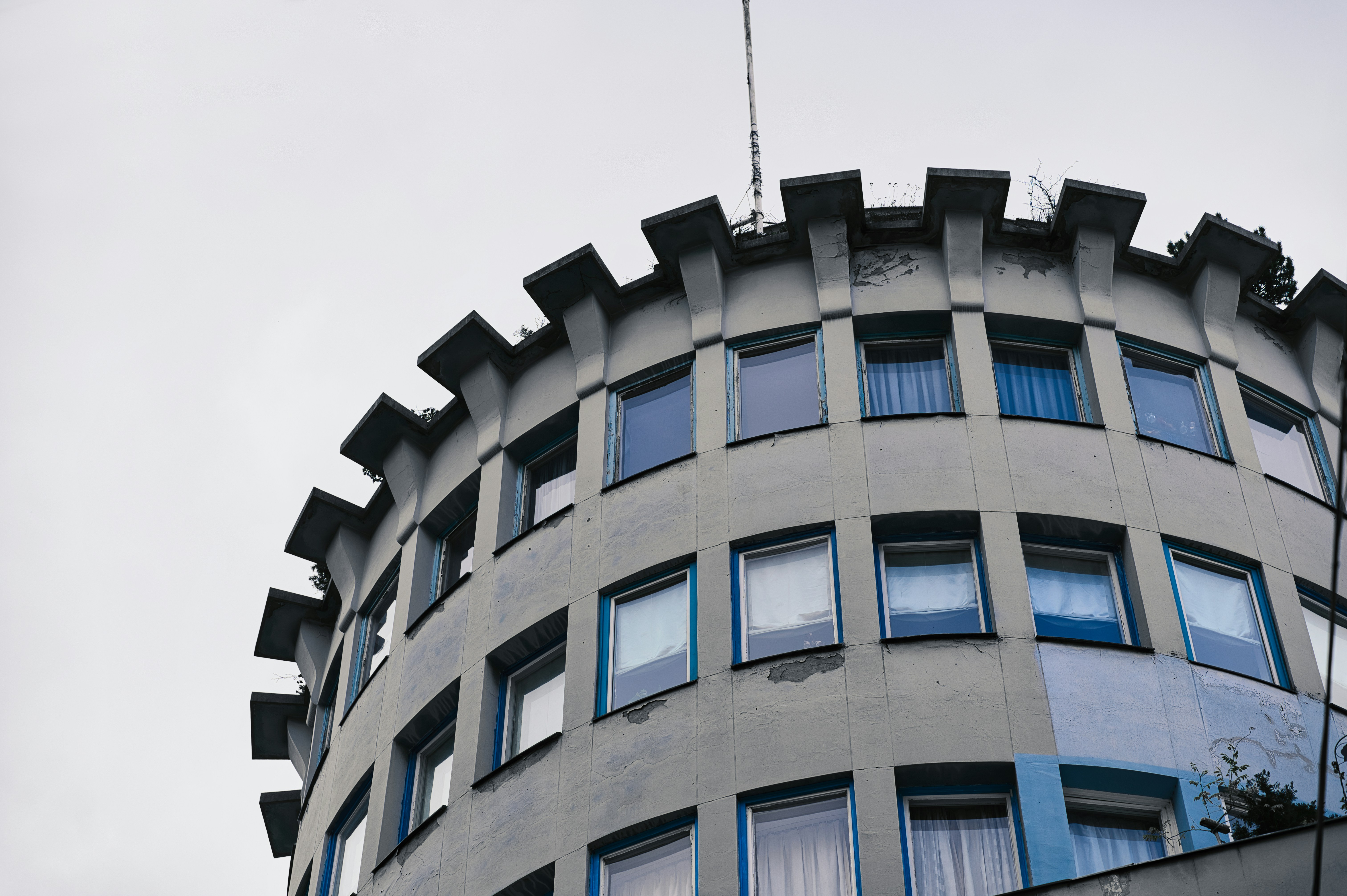 Curved building with many windows and crenellations