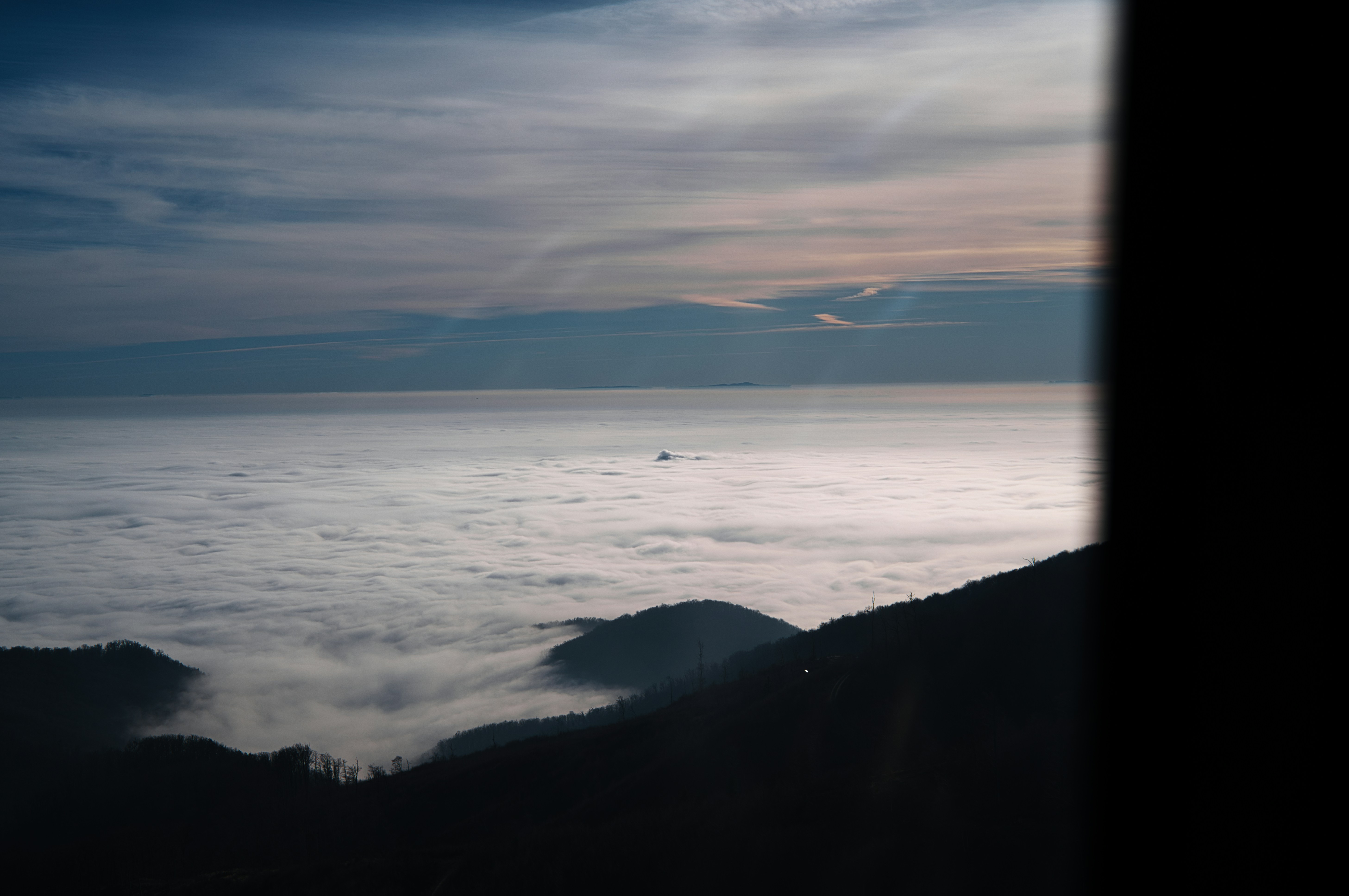 Mountains emerging from a sea of clouds at dawn